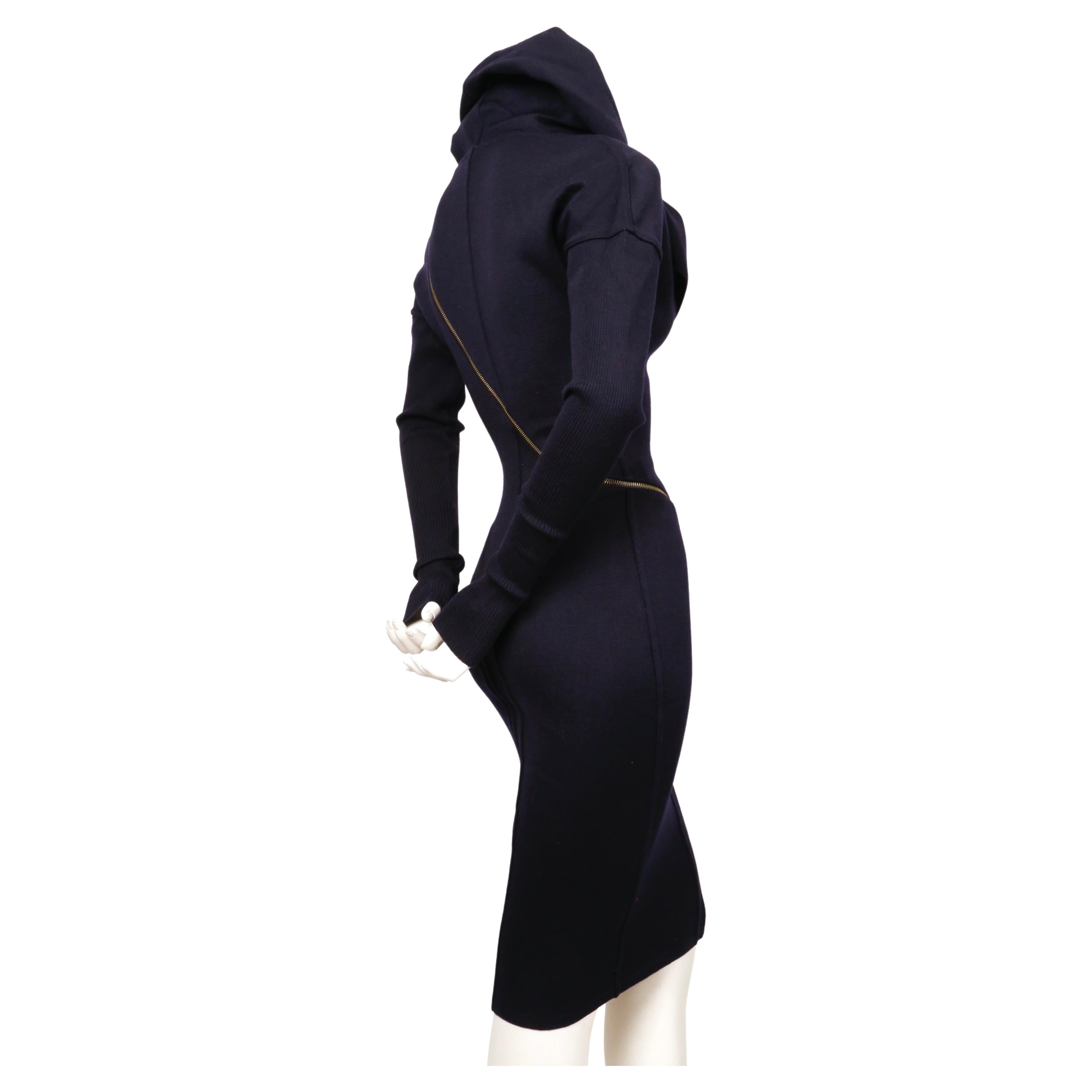 Iconic, navy blue wool, seamed, zipper dress with large hood designed by Azzedine Alaia dating to fall of 1986 as seen on the runway. Well documented piece. Very flattering seams with spiral zipper that cleverly follows the contours of dress seams.