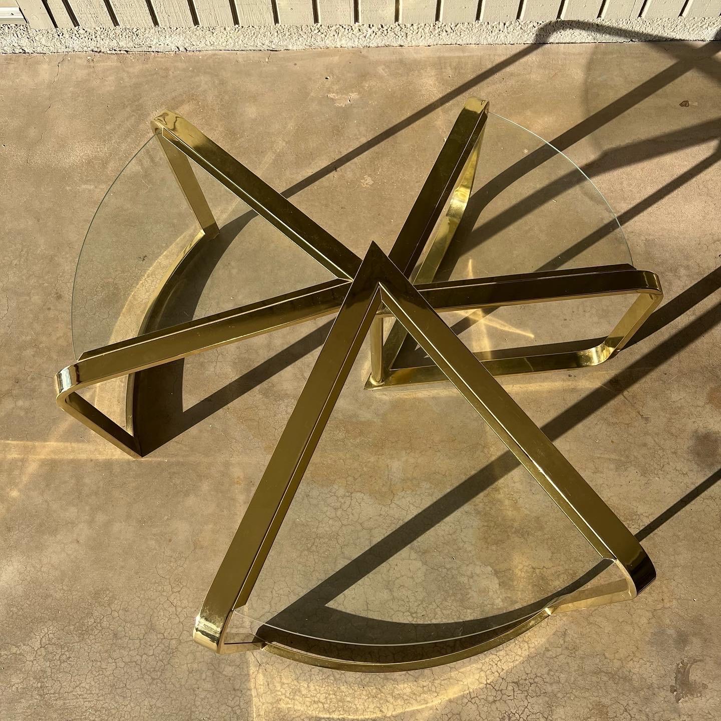 “Fan Nesting Table” by DIA (Design Institute America), labeled, 1986. Brass and glass three-tiered nesting swivel cocktail, side or coffee table designed by Rick Berry. Perfect for any post modern, mid century modern or Hollywood Regency style. This