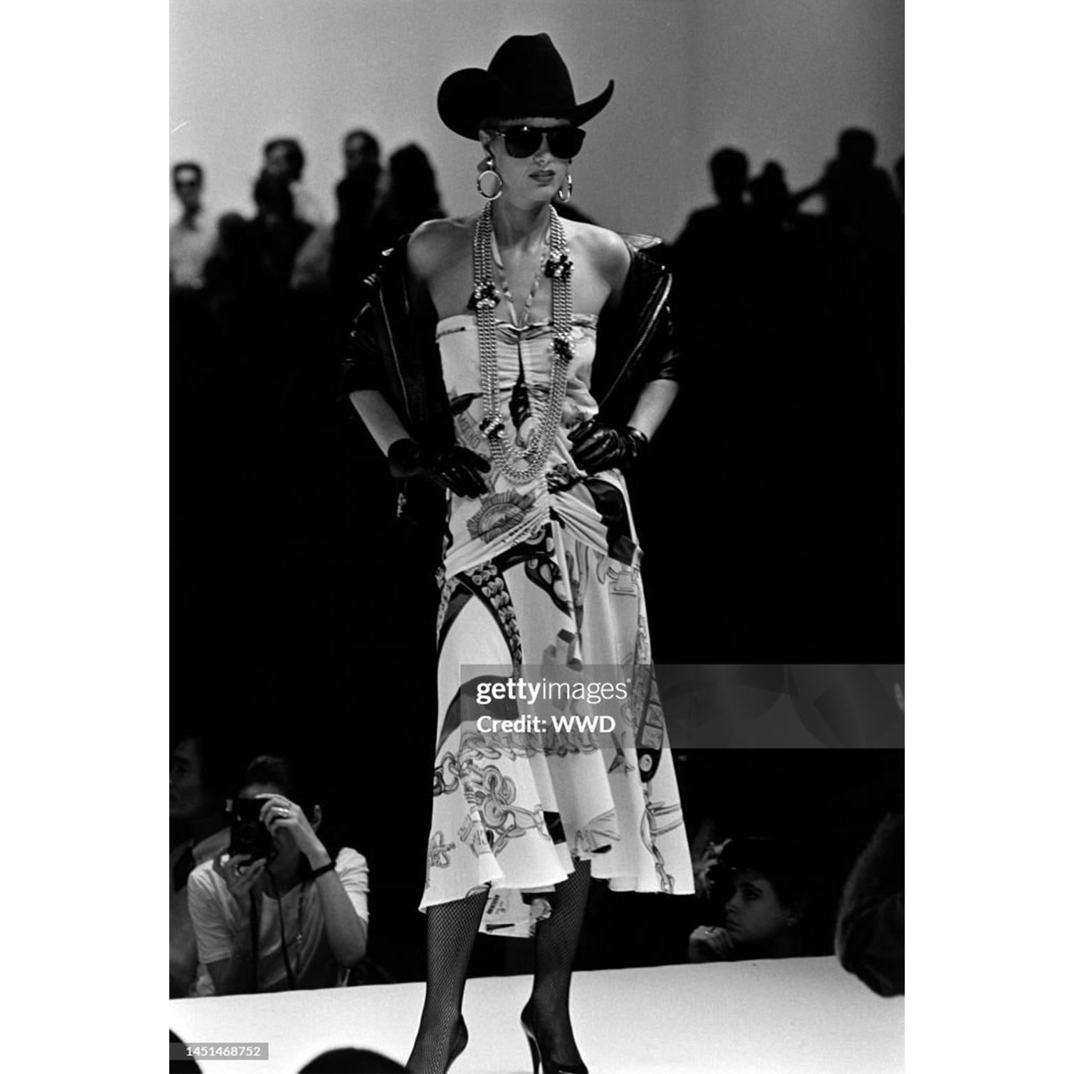 This vintage Moschino dress was designed by Franco Moschino for his Spring/Summer 1986 runway collection. This is a very rare piece from one of our favorite designers. This drawstring halter dress is in a really fun print featuring belts, stars,