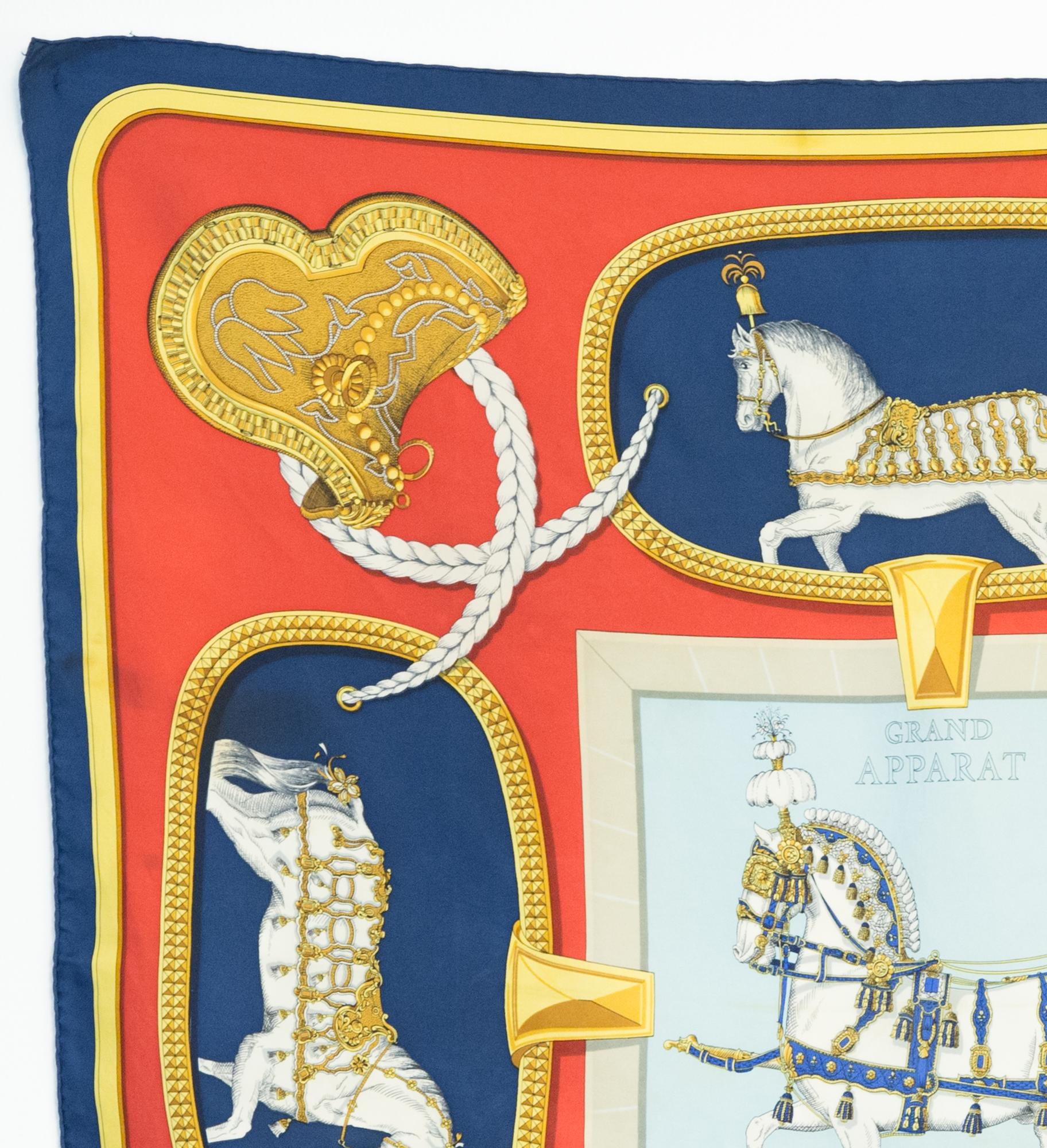 Hermes silk scarf Grand Apparat by Jacques Eudel  featuring a navy border and a Hermès signature. 
First issue 1962 
In good vintage condition (with stains & discolourations). Made in France.
35,4in. (90cm)  X 35,4in. (90cm)
We guarantee you will
