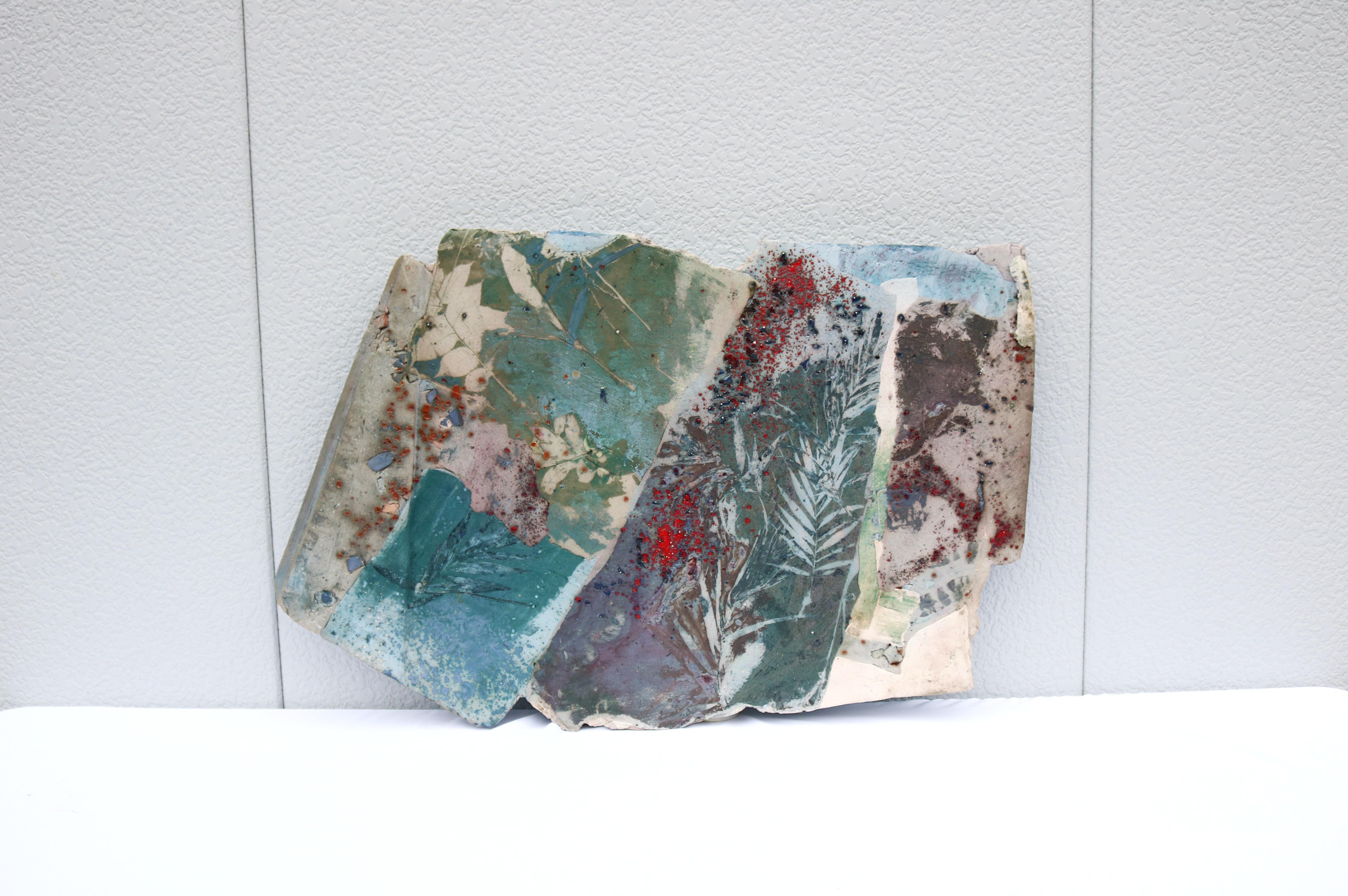 Fabulous 1986 Margie Hughto original one-of-a-kind summer fragments glazed ceramic wall sculpture artwork.
Hand-signed and dated by the artist on the lower right front and titled on the back.
This botanical impression artwork evokes the essence of