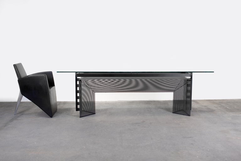 Swiss Architect Mario Botta designed glass and metal prismatic postmodern dining table or conference table. 

Designed in 1986 and made by Alias in Northern Italy.

Large plate glass appears to hover over asymmetrical steel frame, which again,