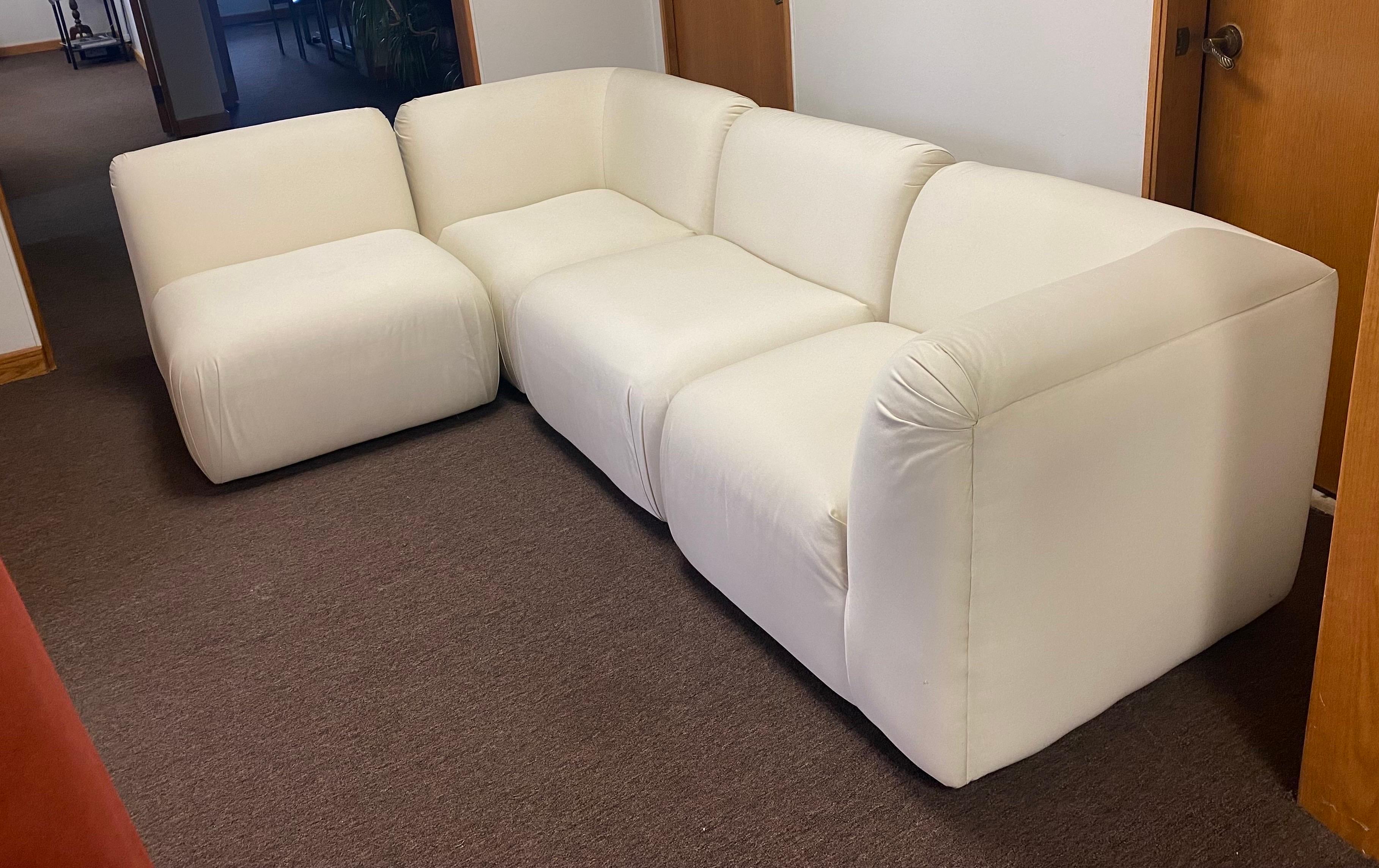 We are very pleased to offer a white, modern, four-piece sectional by Thayer Coggin, circa 1986. Showcasing both curved and linear elements, this piece offers a visual dialogue between structure and shapes. Tailored for a casual lounging experience,