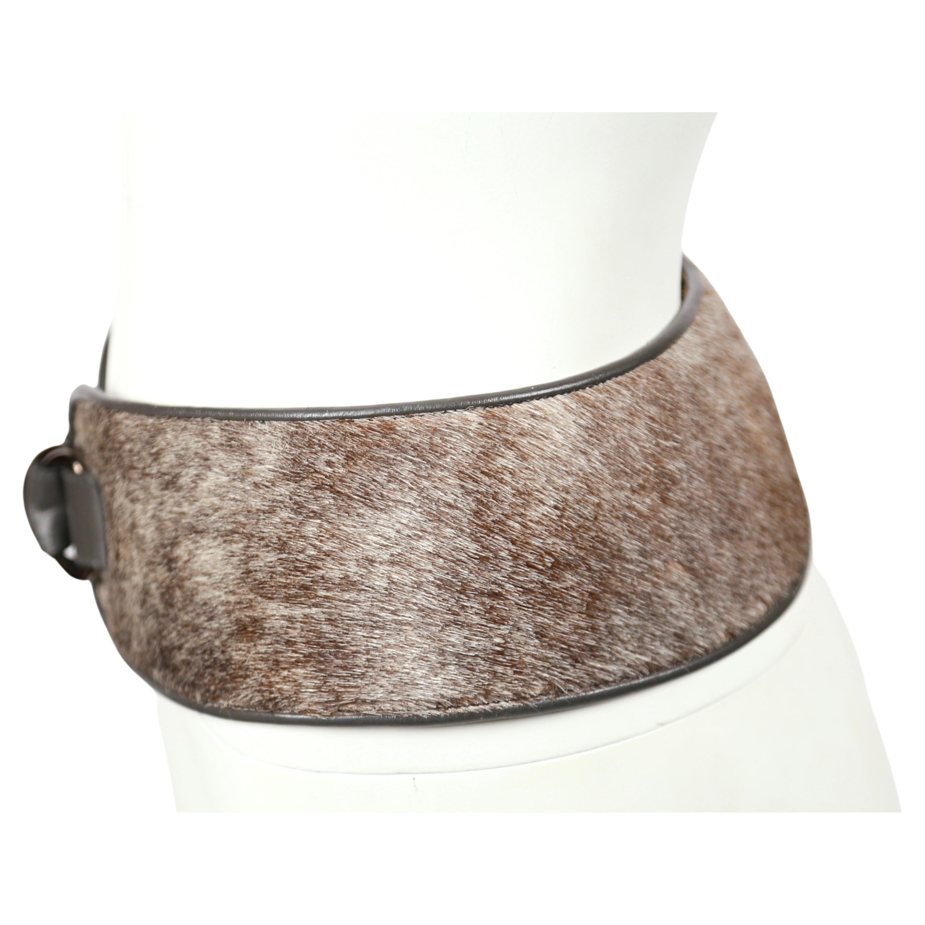 Grey, pony fur belt with grey leather trim from Yves Saint Laurent dating to fall of 1986 as seen on the runway. Labeled a size Medium. Fits a size 4 to 6 (27