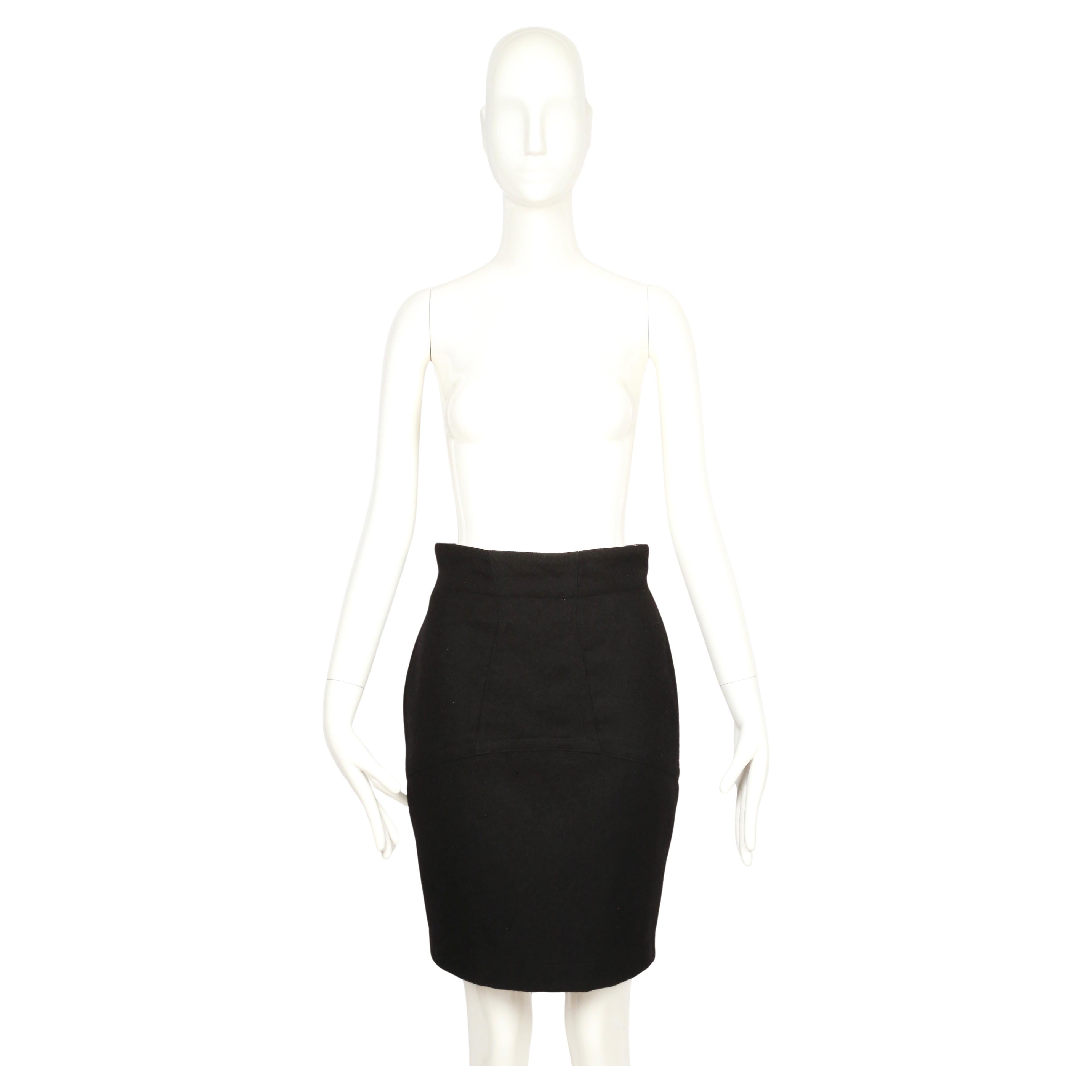 Extremely rare black skirt from Azzedine Alaïa’s Fall/Winter 1987 collection. Constructed in jet black fuzzy worsted wool, the skirt sits high at the waist and is detailed with precise seaming to give it structure through the hips. This early Alaïa