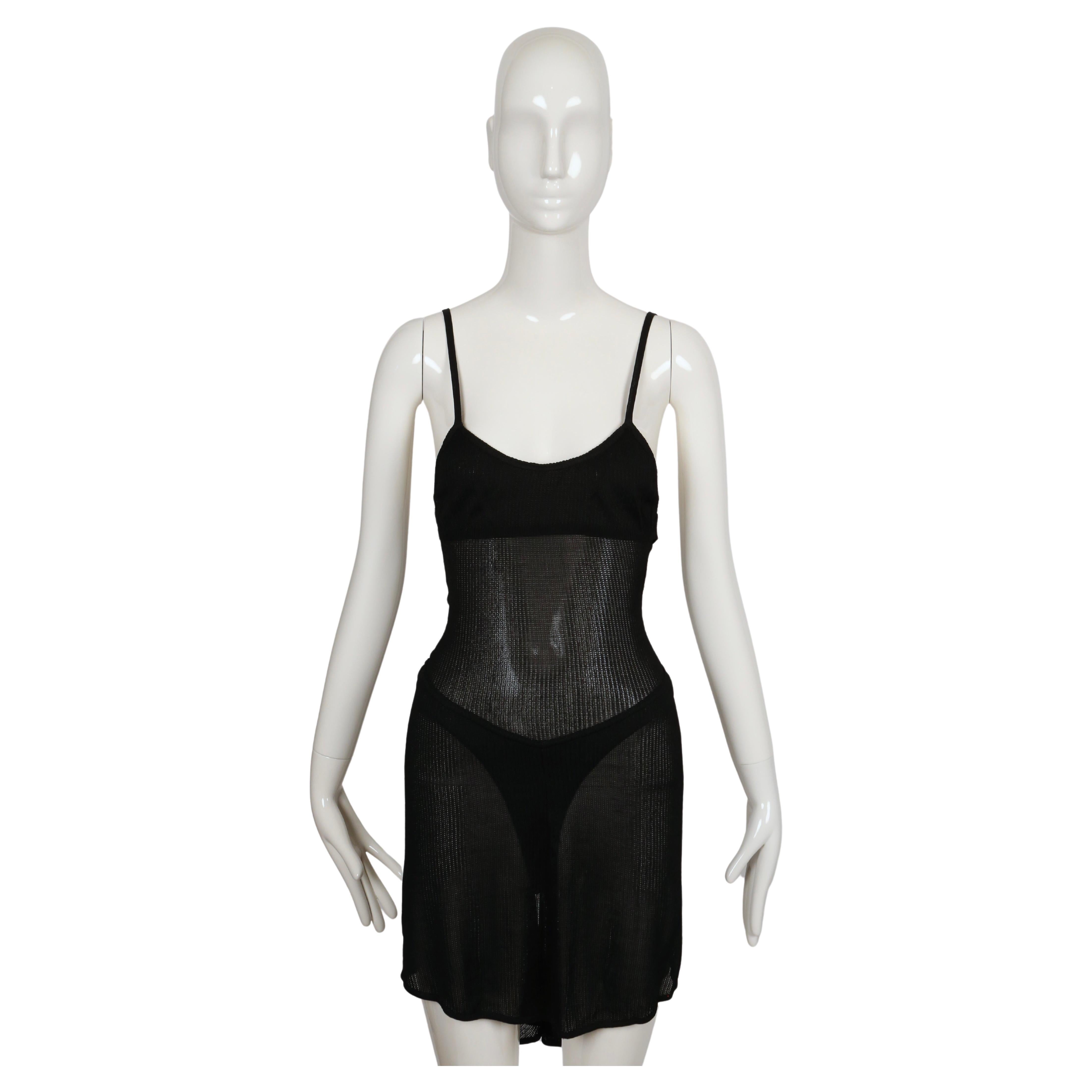Very rare, semi-sheer dress with spaghetti straps and flounced hemline designed by Azzedine Alaia dating to spring of 1987 as seen on the runway in white. Dress is labeled a size M but this better fits an XS/S. Approximate measurements