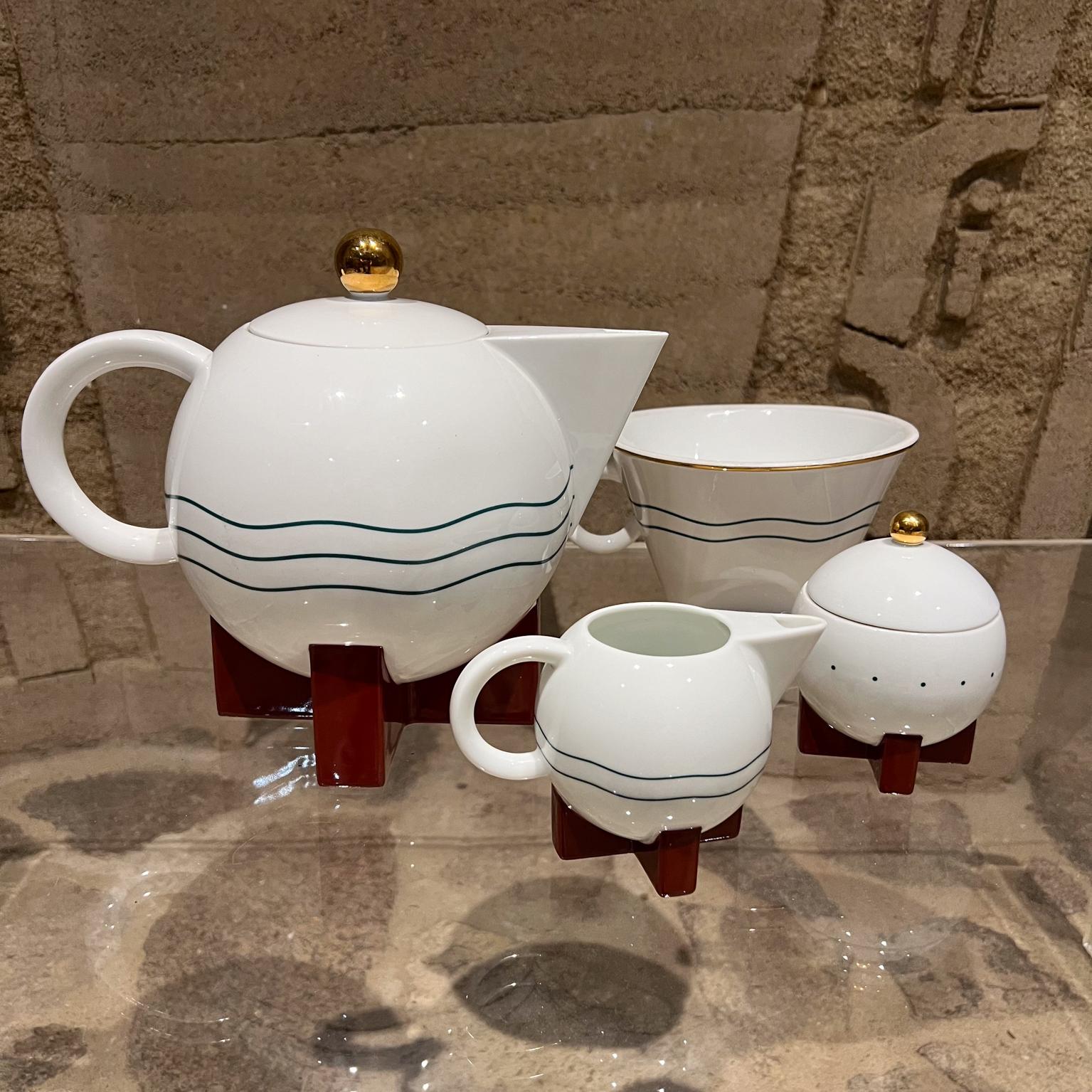 1987 Postmodern Big Dripper Coffee Set by Michael Graves for Swid Powell
High gloss white glaze large pot, filter holder, and lid with gold decoration and brick red base.
Large Coffee Pot 8.75 h x 10.5 d x 7 diameter Coffee filter 4.75 h x 7.5 d x