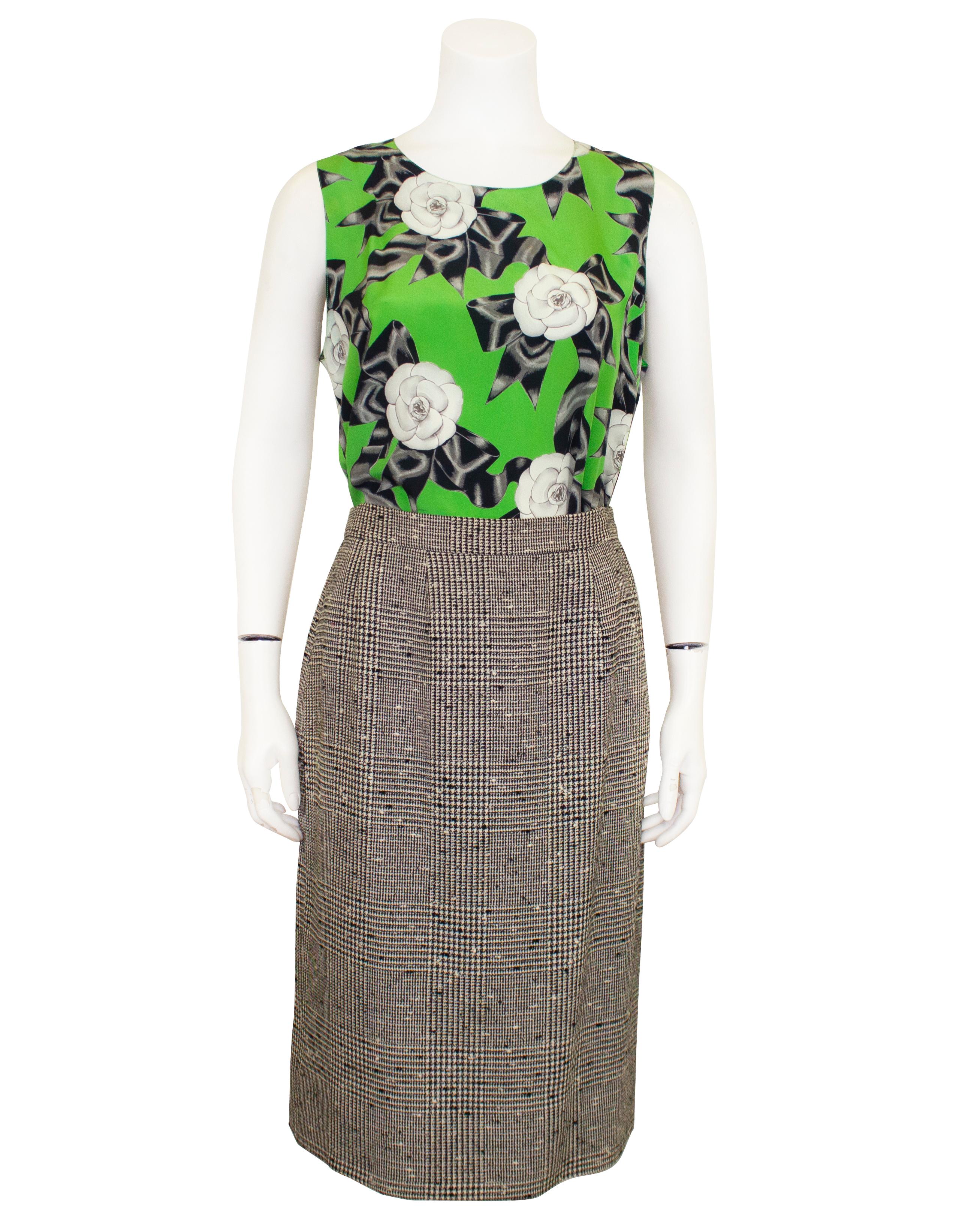 Camellia printed silk lined suit and blouse from the 1987 Spring RTW Collection. The jacket was worn on the runway by Chanel muse Ines de la Fressange. In excellent condition, the jacket has a relaxed shape with a dropped shoulder and is lined in a