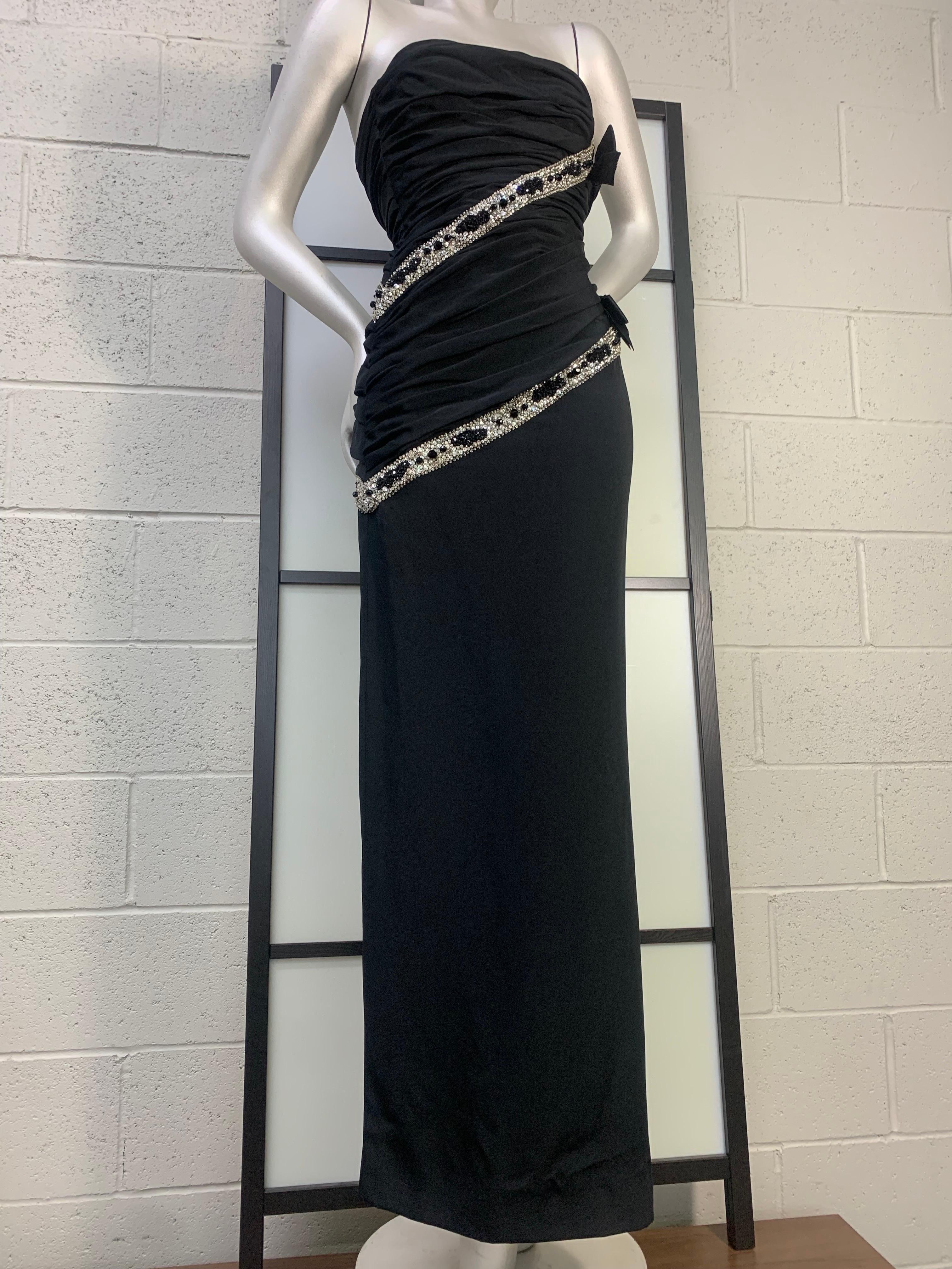 1987 James Galanos Black Silk Crepe Strapless Corset Gown w Crystal Beading: Ruched column gown in a body conscious silhouette with full corselet structure inside.  Diagonal spiraled black and white crystal beaded tape embellishment. High side slit.
