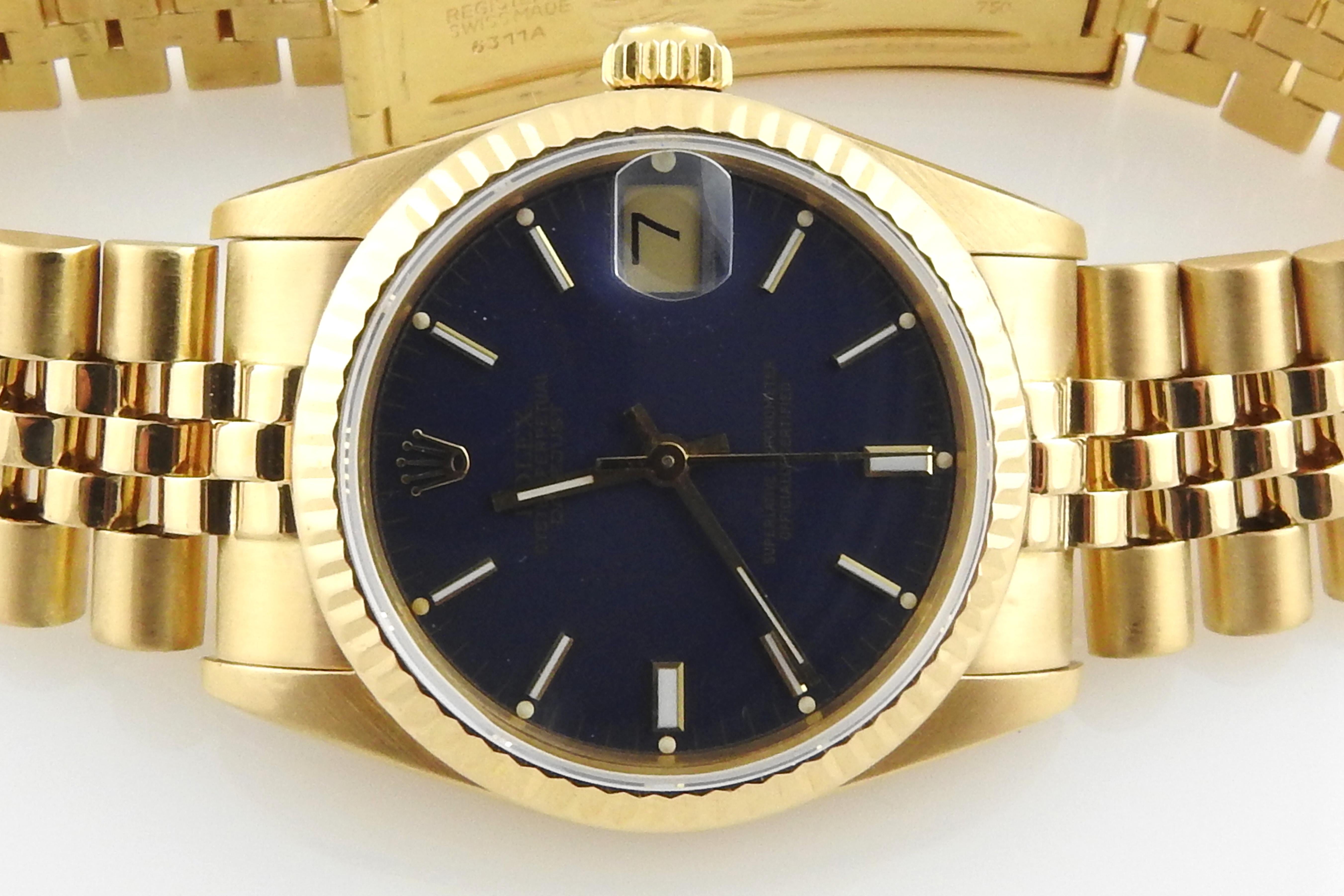 1987 Rolex Midsize 18K Yellow Gold Watch

Model: 68278
Serial: 9743759

Automatic movement

Blue Stick Dial

18K yellow gold case and jubilee band

Band has some stretch as shown. Fits up to 8