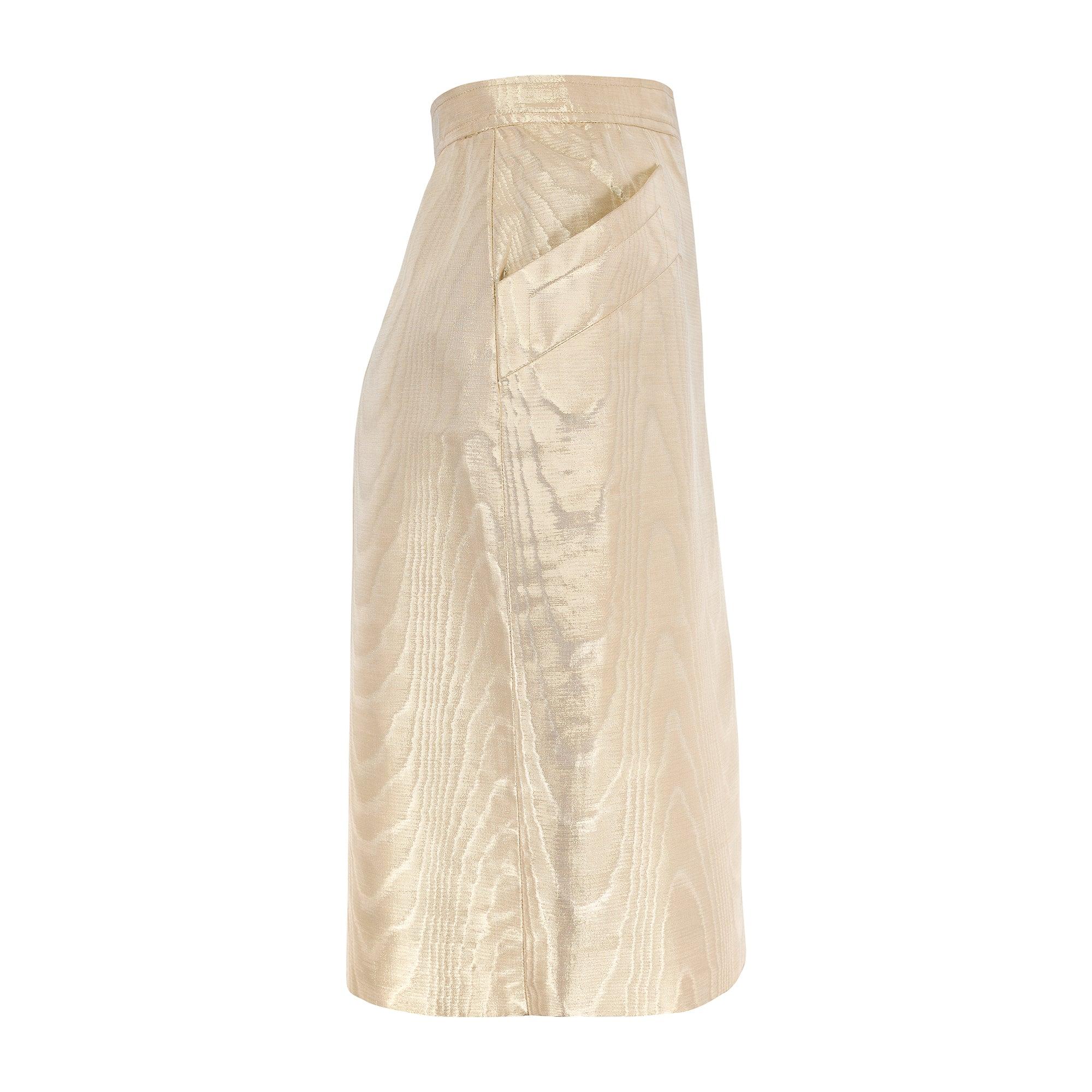 This opulent gold pencil skirt walked the runway as part of Saint Laurent’s Fall 1987 collection. Crafted from a mesmerising thick metallic cotton-mix moiré, it epitomises the decadence of the era of excess. Tailored to a pencil skirt style, it has