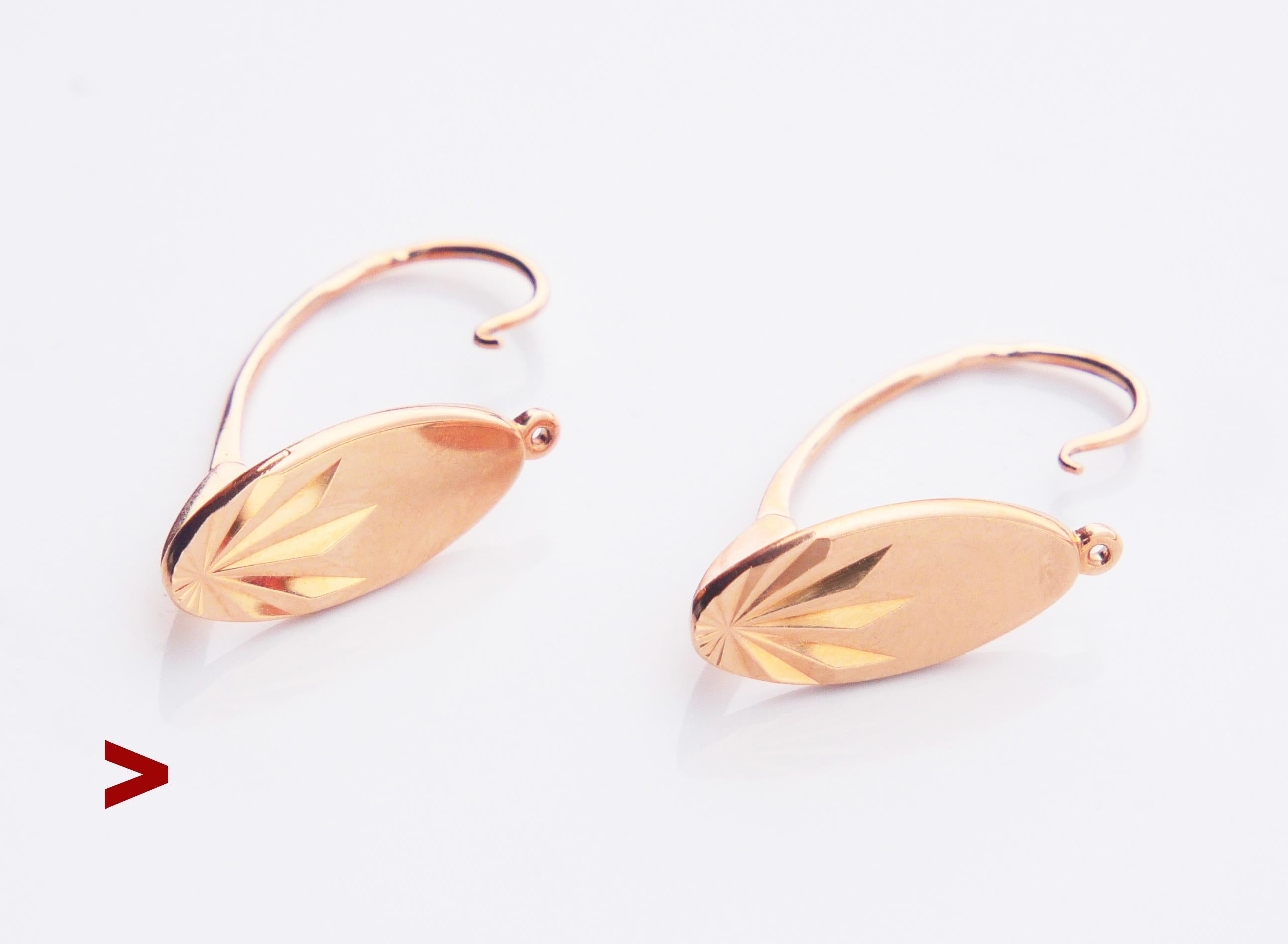 A pair of Soviet Earrings in solid 14K Rose Gold with star - burst engravings and folding hooks.

Each earring is marked with Soviet Union period hallmarks : five pointed star, 583, assay and Jewelry factory marks of Leningrad city, made in
