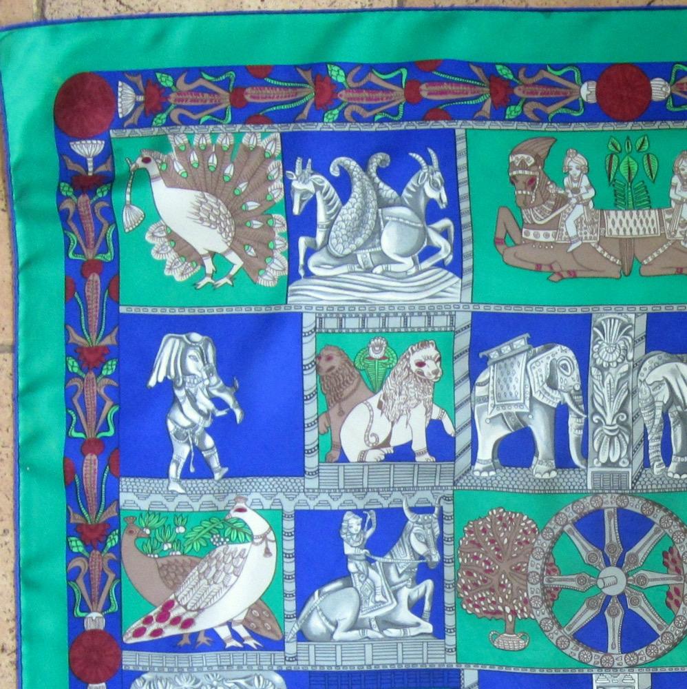 Hermes silk scarf “Torana” by Annie Faivre featuring a green border and a Hermès signature. 
Circa: 1987
In good vintage condition. Made in France.
35,4in. (90cm)  X 35,4in. (90cm)
We guarantee you will receive this  iconic item as described and