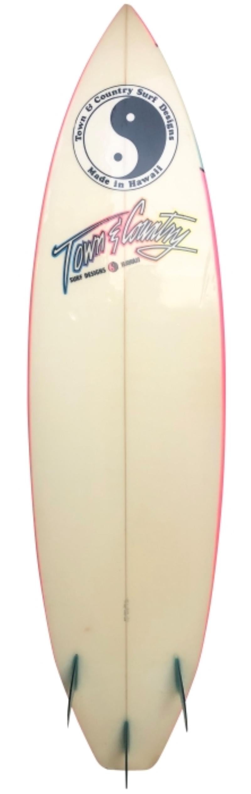 1987 Town & Country shortboard shaped by Mike Casey. Features a stunning neon pink airbrush design complete with beautiful aqua blue thruster (tri-fin) setup. A remarkable example of a 1980s shortboard in all original condition.