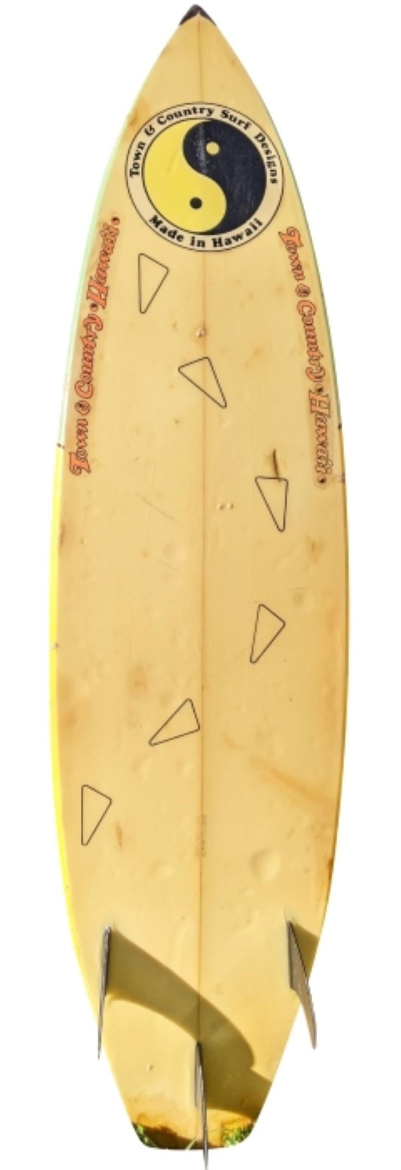 1987 Town & Country Surfboards (T&C) shaped by the late Ben Aipa (1942-2021). Features a iconic 1980s style airbrushed art design with glassed on thruster (tri-fin) setup. Signed “Ben Aipa Hawaii” on the deck. A great example of an airbrushed T&C