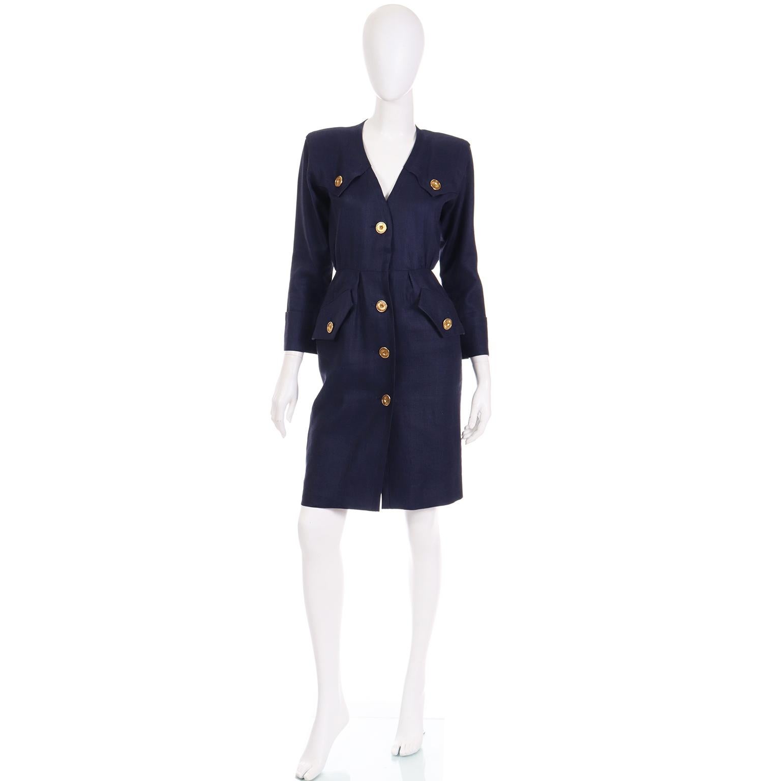 This vintage 1987 Yves Saint Laurent long sleeve dress is in a luxe dark navy blue flax linen. The dress has large gold buttons and it can be worn with or without a belt you already own! This dress style was a signature look throughout YSL's career,
