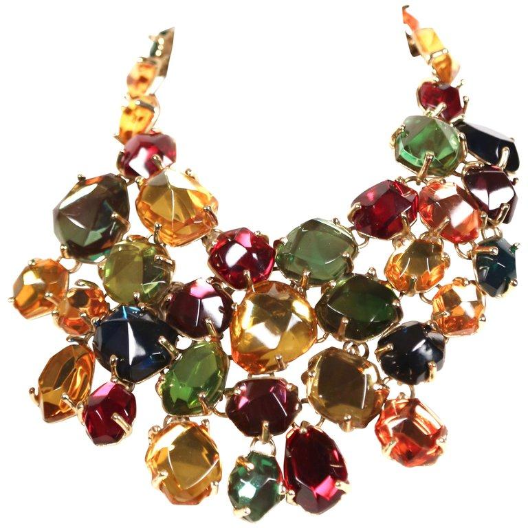 Dramatic, oversized, poured glass, bib necklace designed by Loulou de la Falaise for Yves saint Laurent dating to 1987. Necklace features multi-color faceted 'stones' set in gold-gilt metal. Adjustable hook closure. Adjusts from 16-18