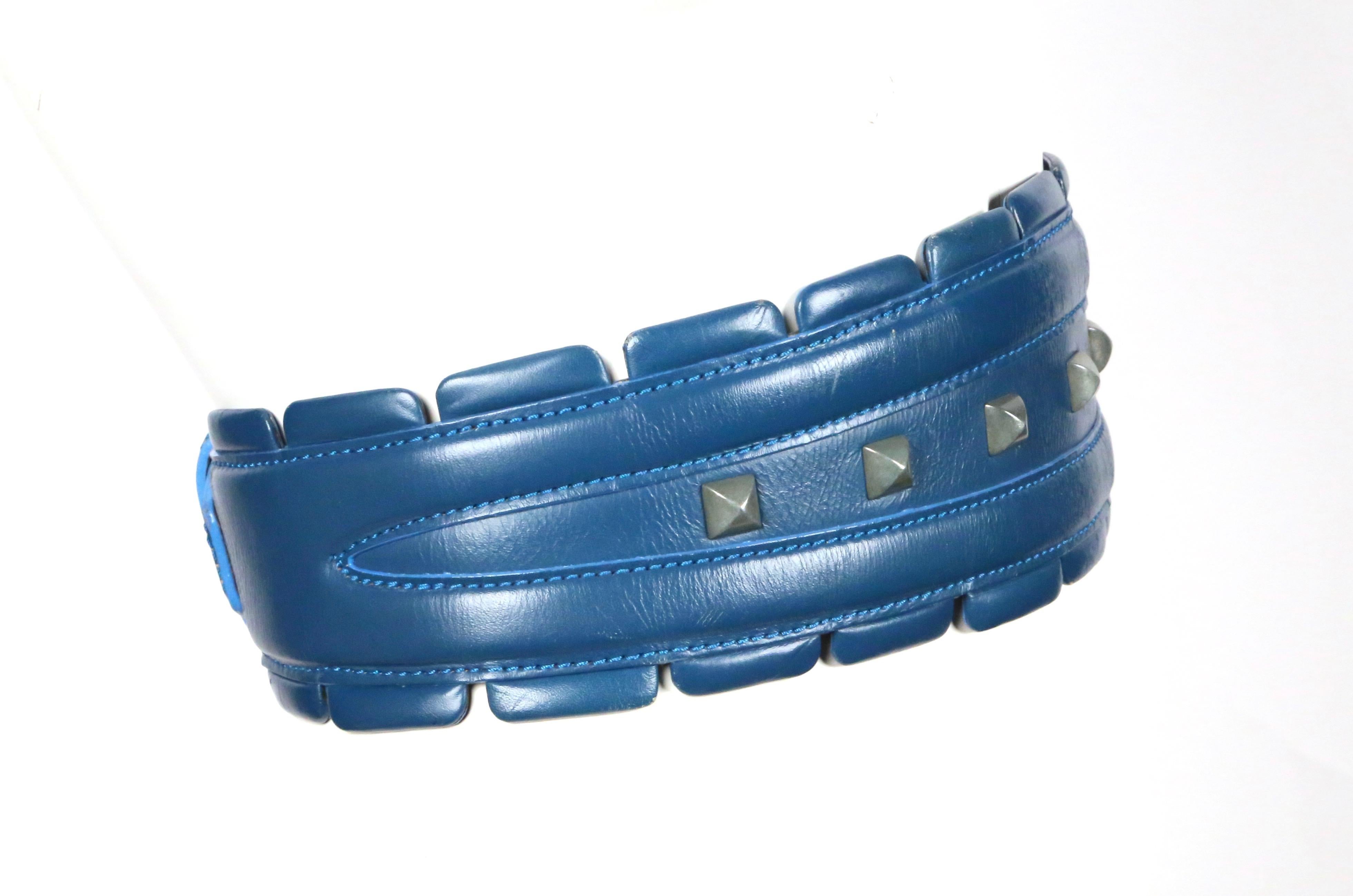 Very rare, blue-green leather belt with gunmetal pyramid studs from Azzedine Alaia as seen on the fall 1988 runway. Belt is labeled a French 65 and ideally fits a 23-24.5