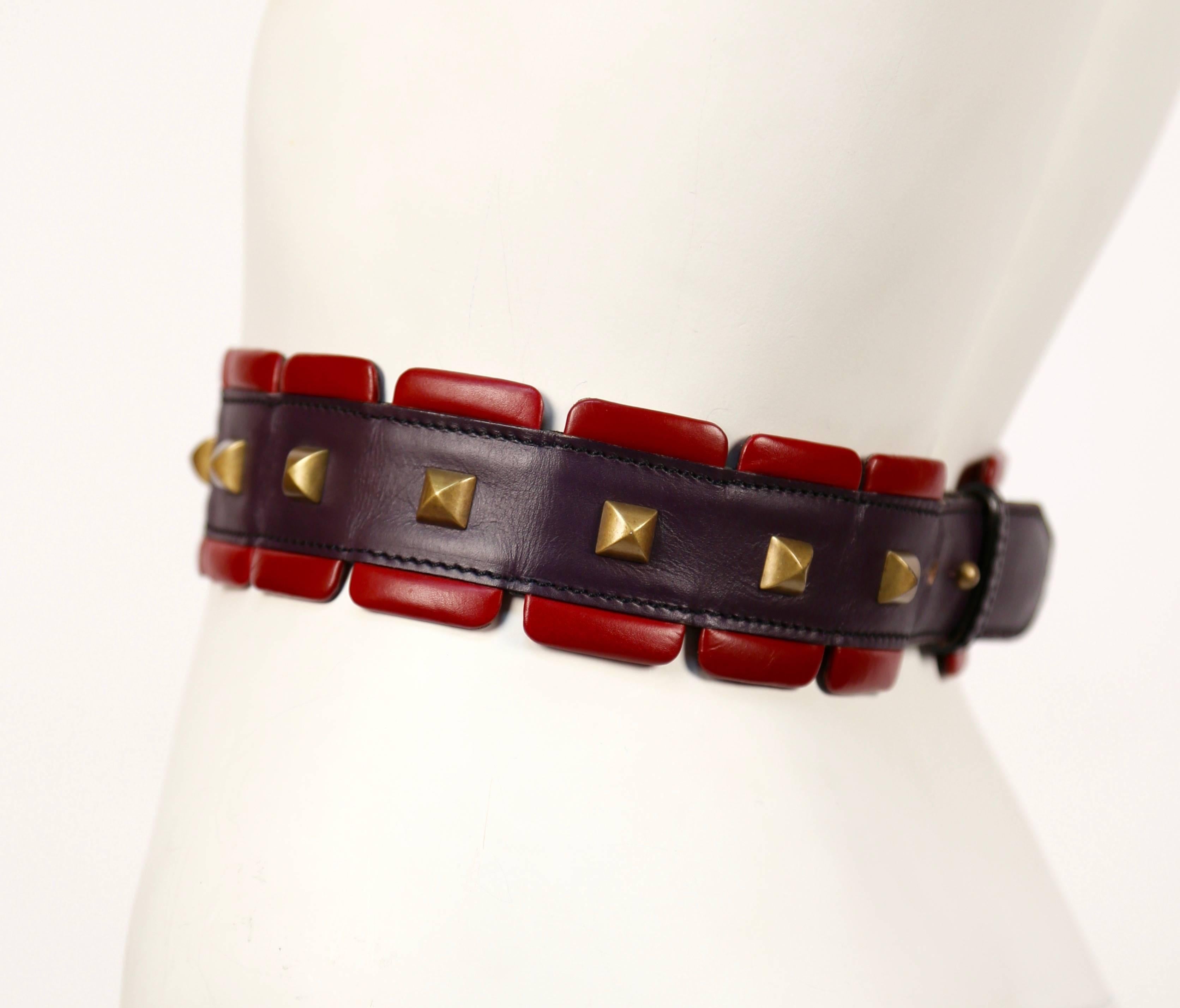 Unique, red and purple leather belt with brass pyramid studs from Azzedine Alaia as seen on the fall 1988 runway. Best is labeled a French size 65. Width is 2.25