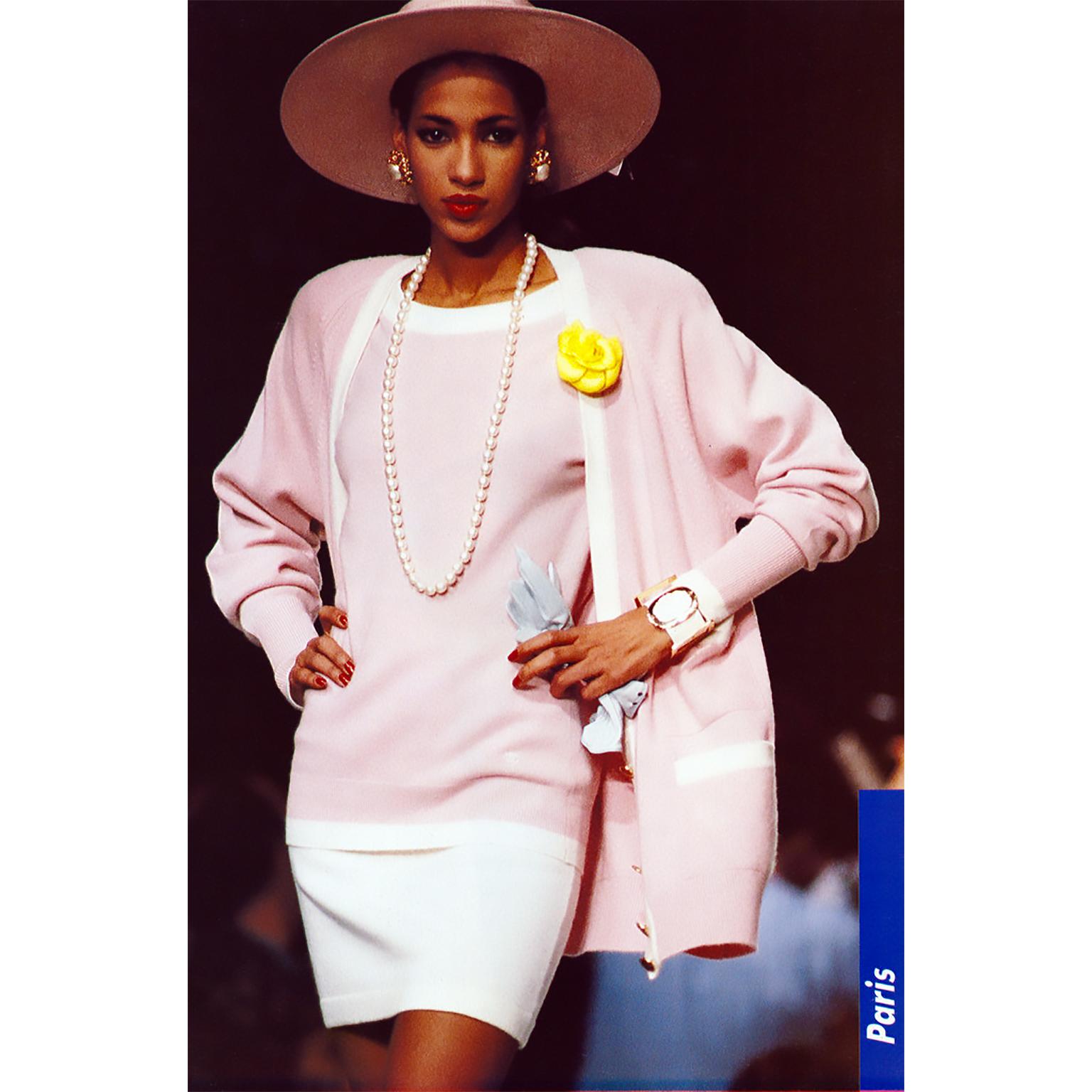 This pretty pink cashmere ensemble from Chanel came from the estate of a woman who worked at Chanel in the 70's and 80's.  The top is pink with cream ribbed trim and the skirt is solid pink. The skirt has its original tags. This is a timeless outfit