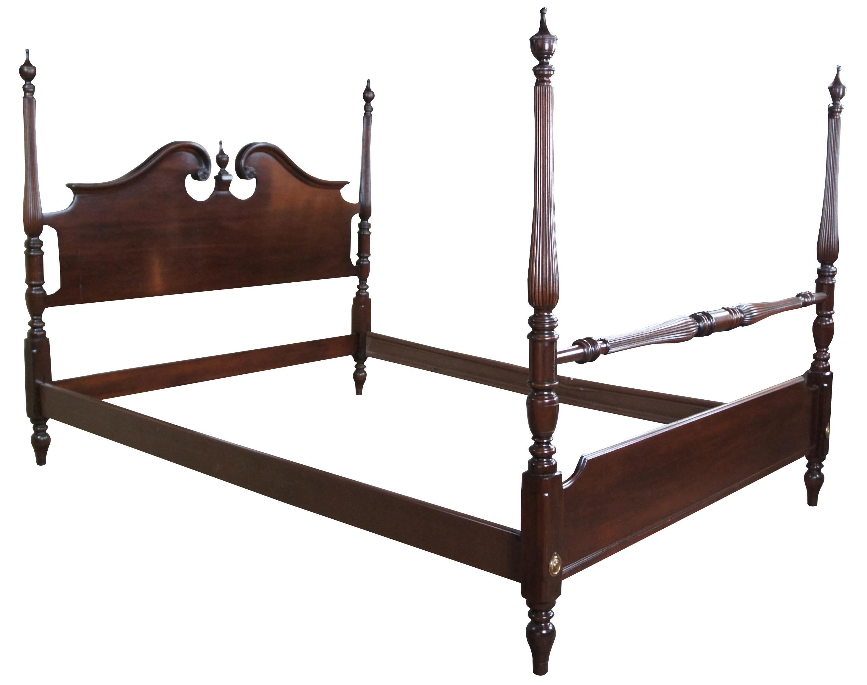 Vintage 1988 Ethan Allen Georgian Court pediment poster bed. Made of dark cherry featuring serpentine form with open pediment, finials, fluting and floral medallions. 11-5654. 225.

Measures: 56.5