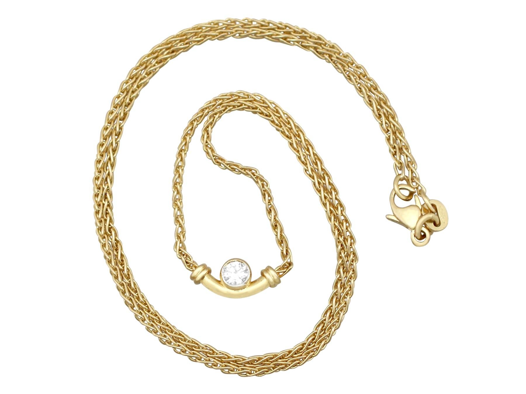 An impressive vintage 0.17 carat diamond and 18 karat yellow gold necklace; part of our diverse diamond jewelry and estate jewelry collections.

This fine and impressive diamond pendant has been crafted in 18k yellow gold.

The curbed tubular
