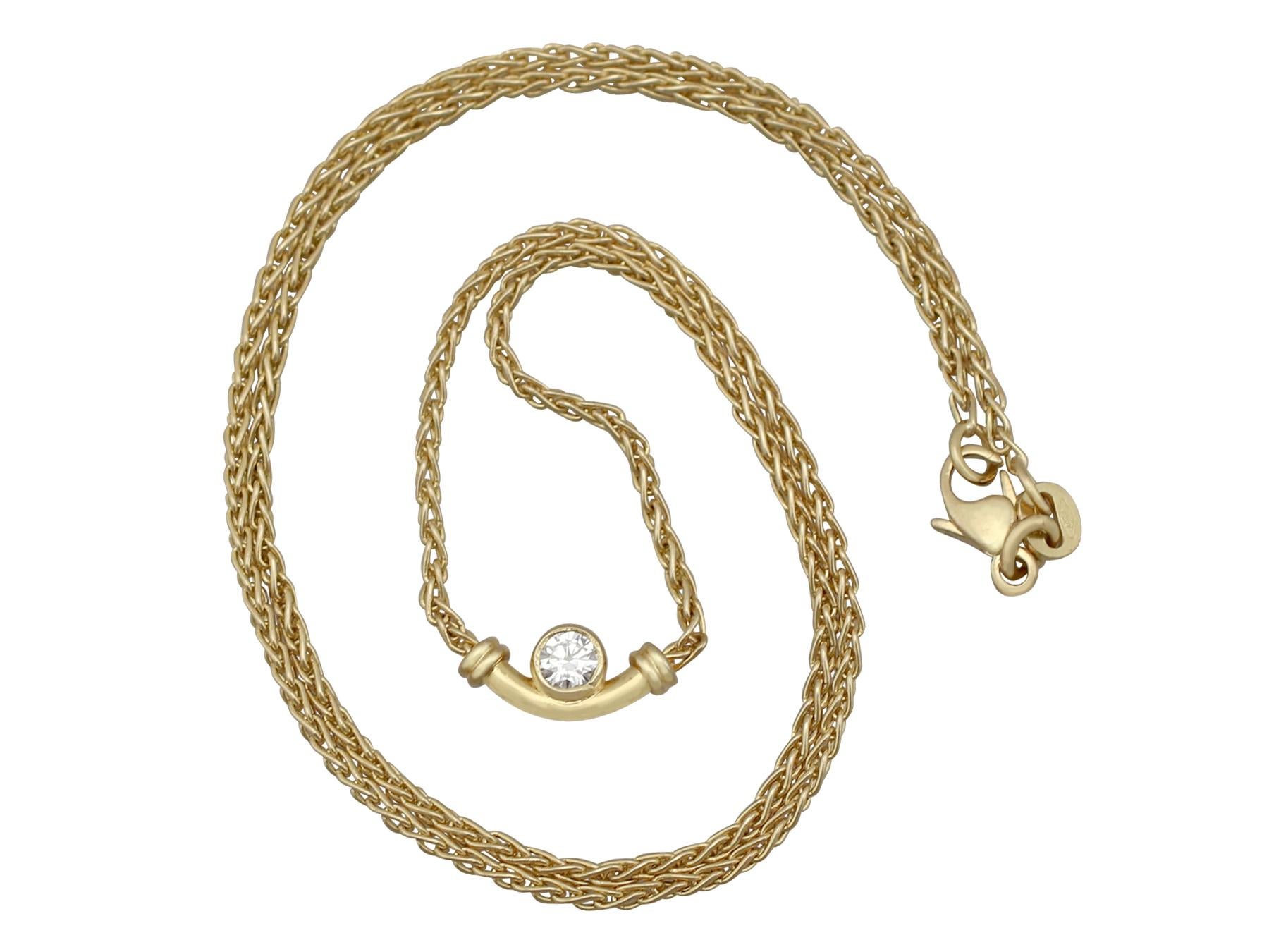 An impressive vintage 0.17 carat diamond and 18 karat yellow gold necklace; part of our diverse diamond jewelry and estate jewelry collections.

This fine and impressive diamond pendant has been crafted in 18k yellow gold.

The curbed tubular