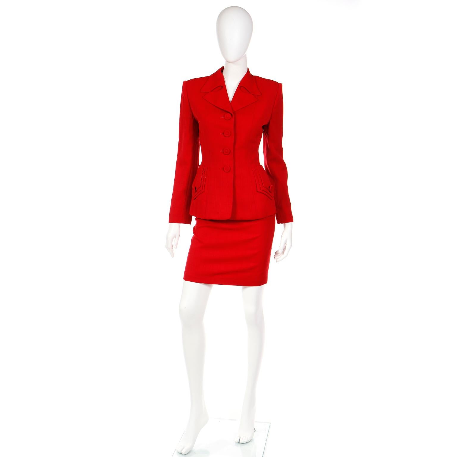 This is such a fun avant garde skirt suit by Norma Kamali from 1988. It is a red wool skirt and jacket suit with tonal windowpane plaid grid pattern and cutouts in the lapels that look like flame licks. The beautiful fitted jacket is a 1940s style,
