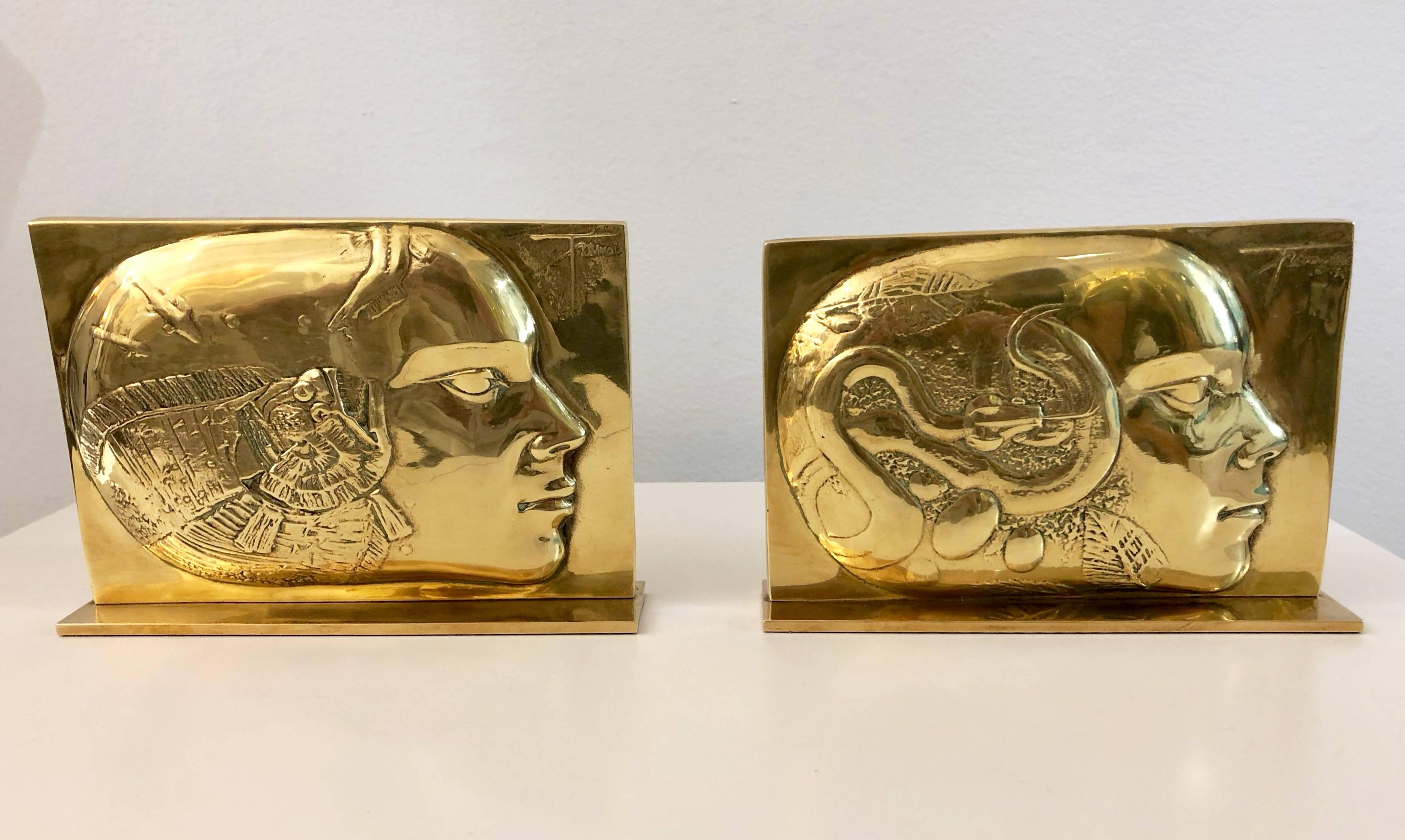 Expressive modern French Work of Art signed by the artist, pair of finely detailed gold color bronze sculptures representing a low relief panel with two different feminine profiles, one with a fish and the other with a snake, intricately chased as