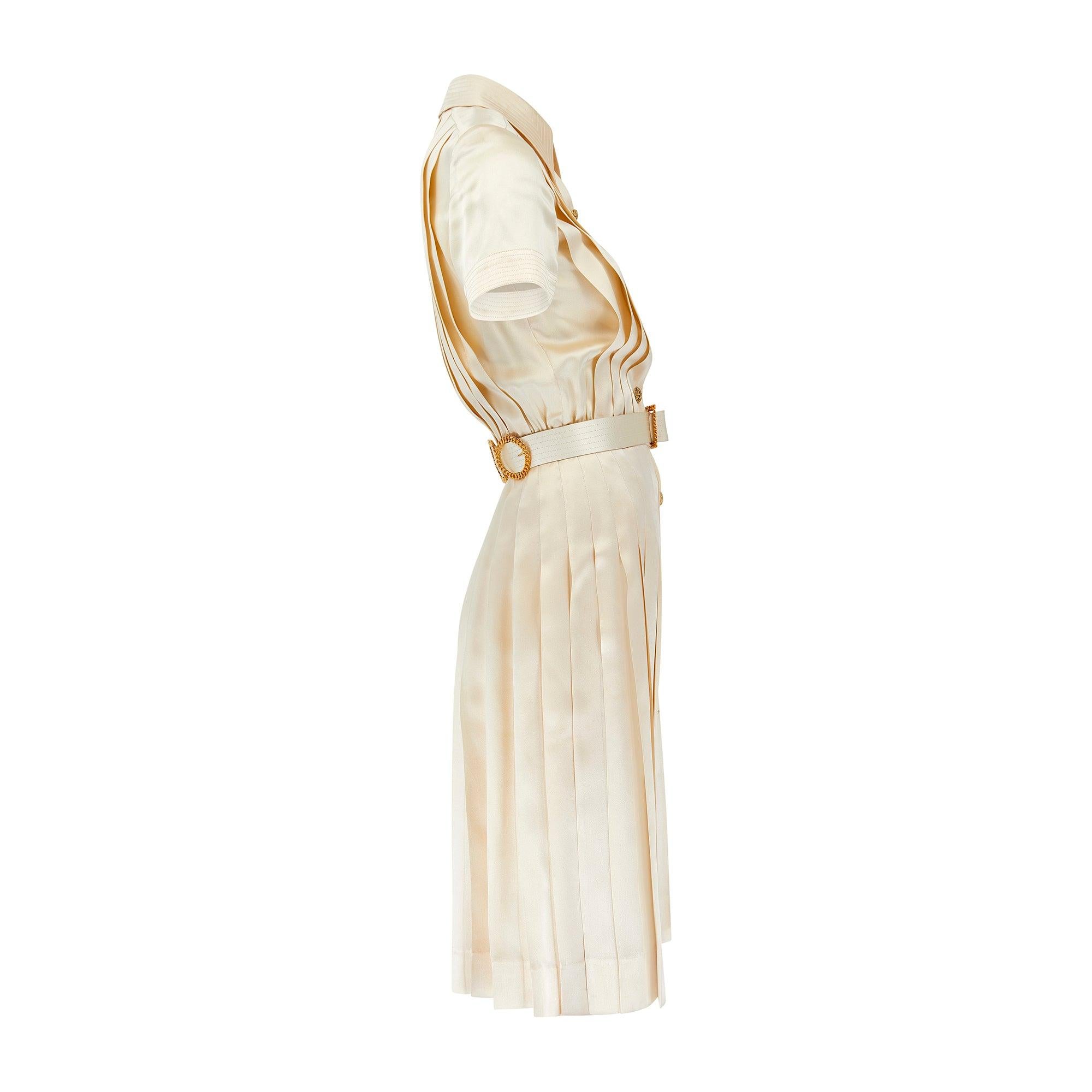 This elegant Chanel cream silk dress featured in the editorial campaign and walked the runway for the brand's spring/summer 1988 collection. Bringing the brand’s tailoring sophistication to a timeless shirt-dress silhouette, this piece is cut with a