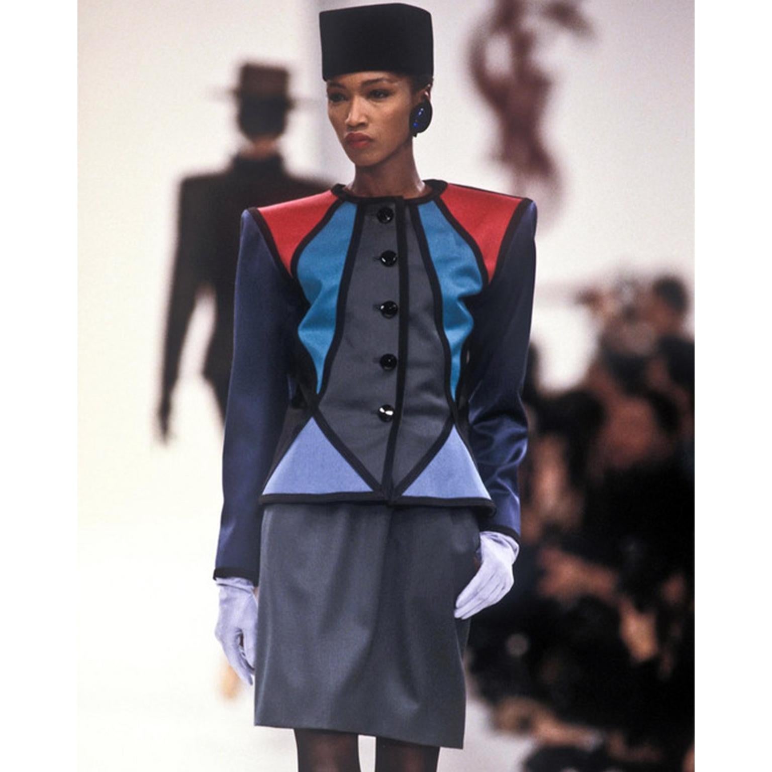 This is a truly stunning vintage Yves Saint Laurent Rive Gauche jewel tone color block jacket and skirt suit. The blazer style jacket is constructed with geometric panels in shades of teal, burgundy red, green, and blue. This gorgeous vintage suit