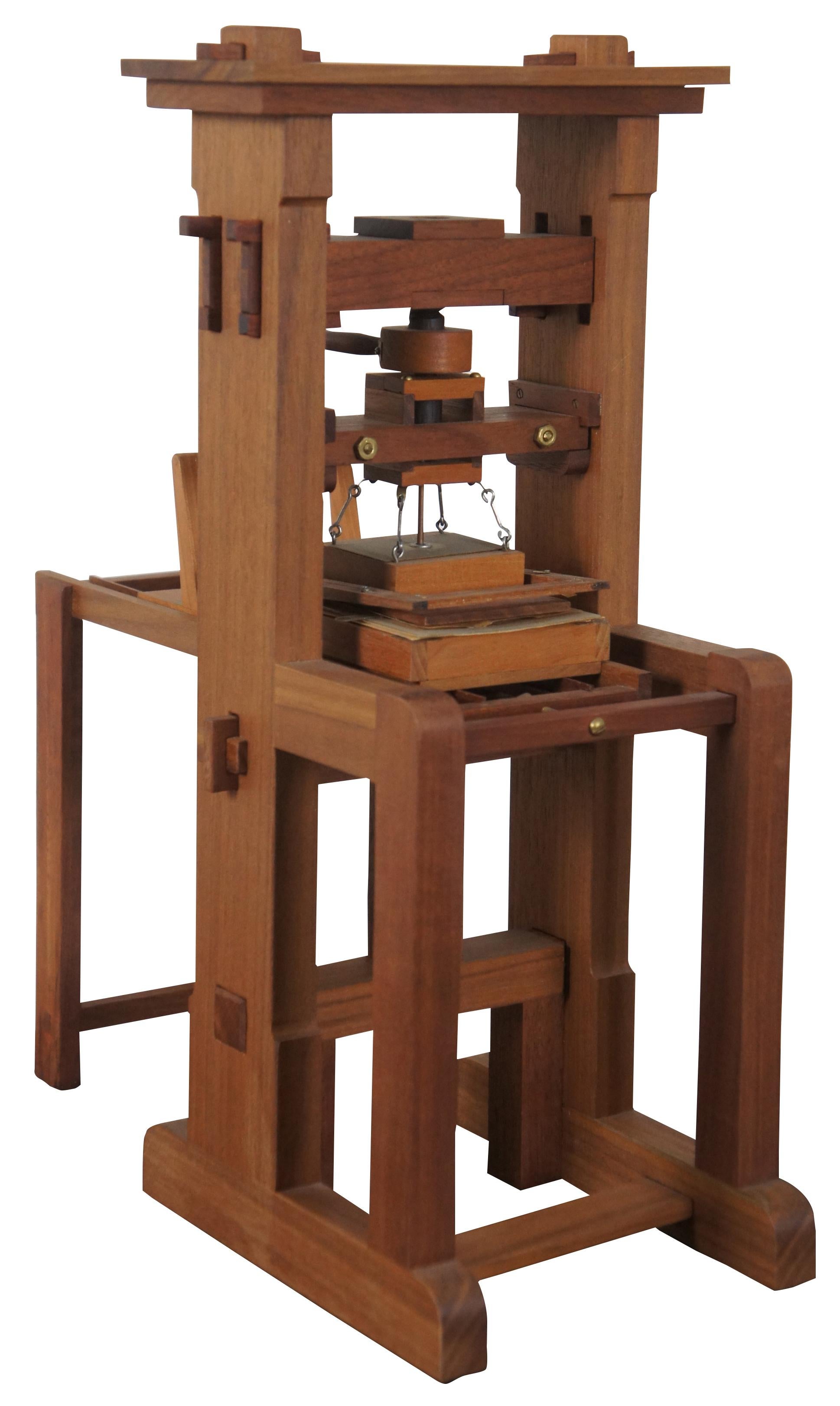 Vintage 1989 ¼ scale model Gutenberg printing press from the miniature book society’s conclave seven keepsake, including linoleum block print made by Kalman L. Levitan. Measures: 17