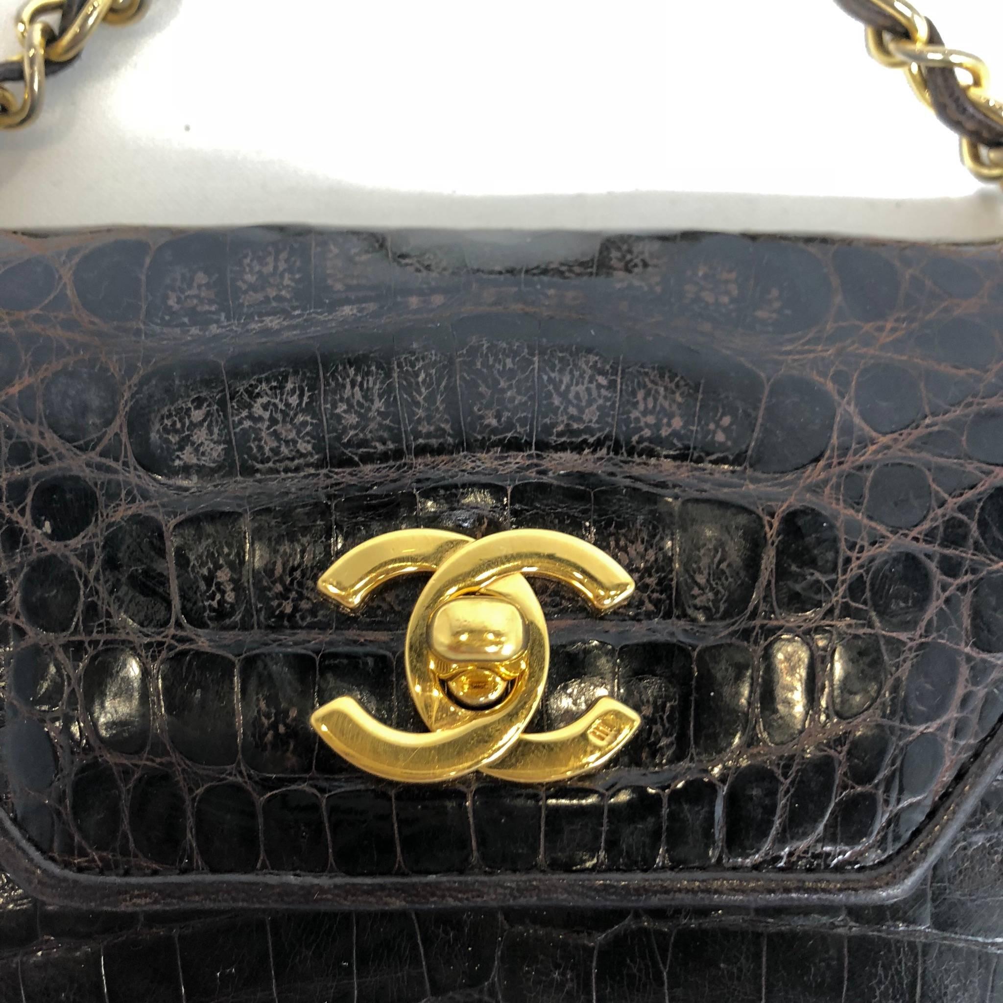 Vintage late 1980’s brown crocodile bag with gold hardware and chain strap. 