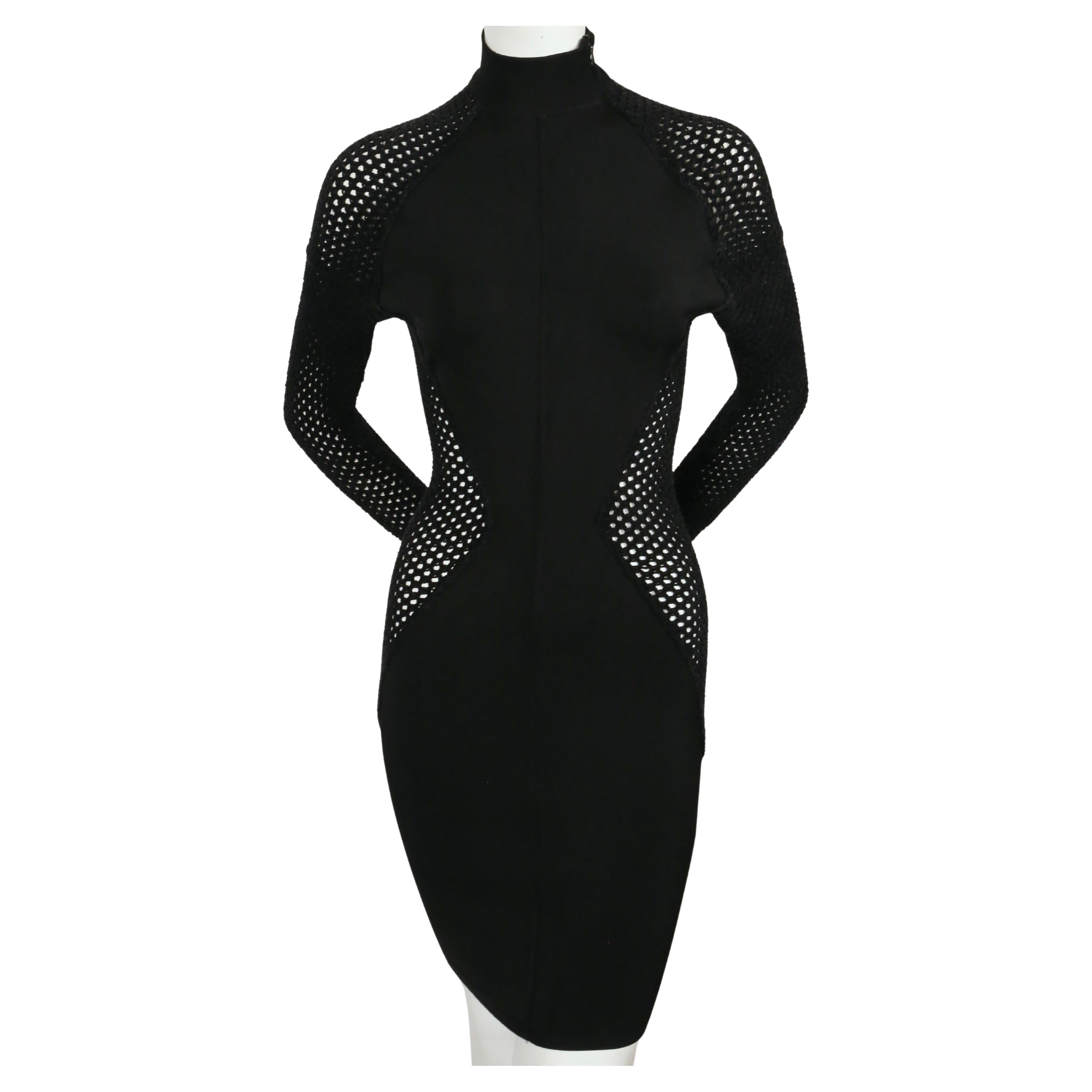 Black viscose dress with sheer, chenille, open-net panels designed by Azzedine Alaia, exactly as seen on the fall 1989 runway.  The main portion of the dress is made of a cool to the touch viscose and the net portion is made of a textured chenille