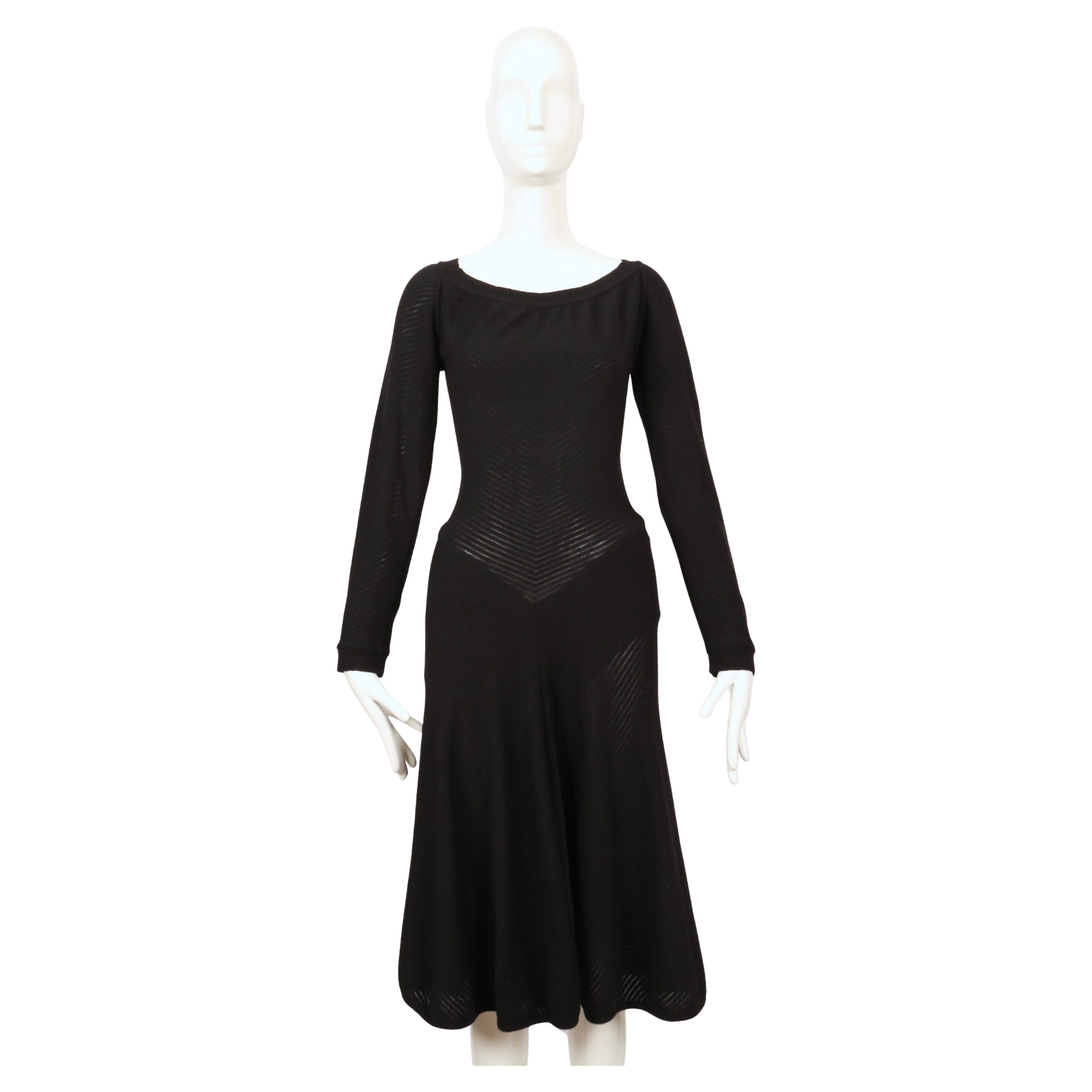 Very rare, semi sheer ribbed black dress with low back and ruching at back of waist from Azzedine Alaia dating to 1989. No size tag although this best fits a M. Approximate measurements (unstretched): bust 34-36, waist 25-26