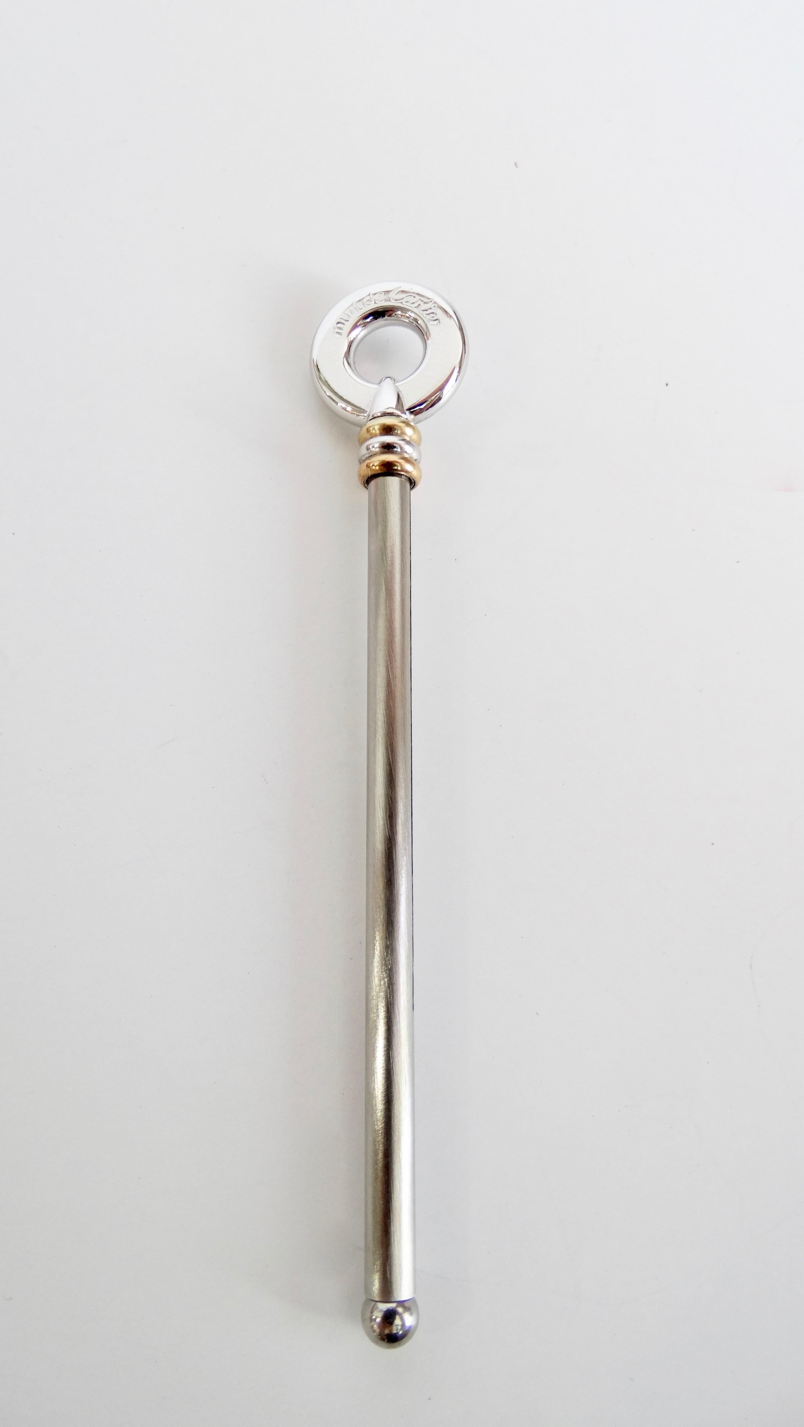 Gorgeous rare Cartier mixed precious metal swizzle stick circa 1989. Crafted in palladium and 18k gold. Features 3 ring design which releases the retractable whisk. The object is signed on the ring, 'Cartier Paris' and 'C Cartier 1989'. Measures