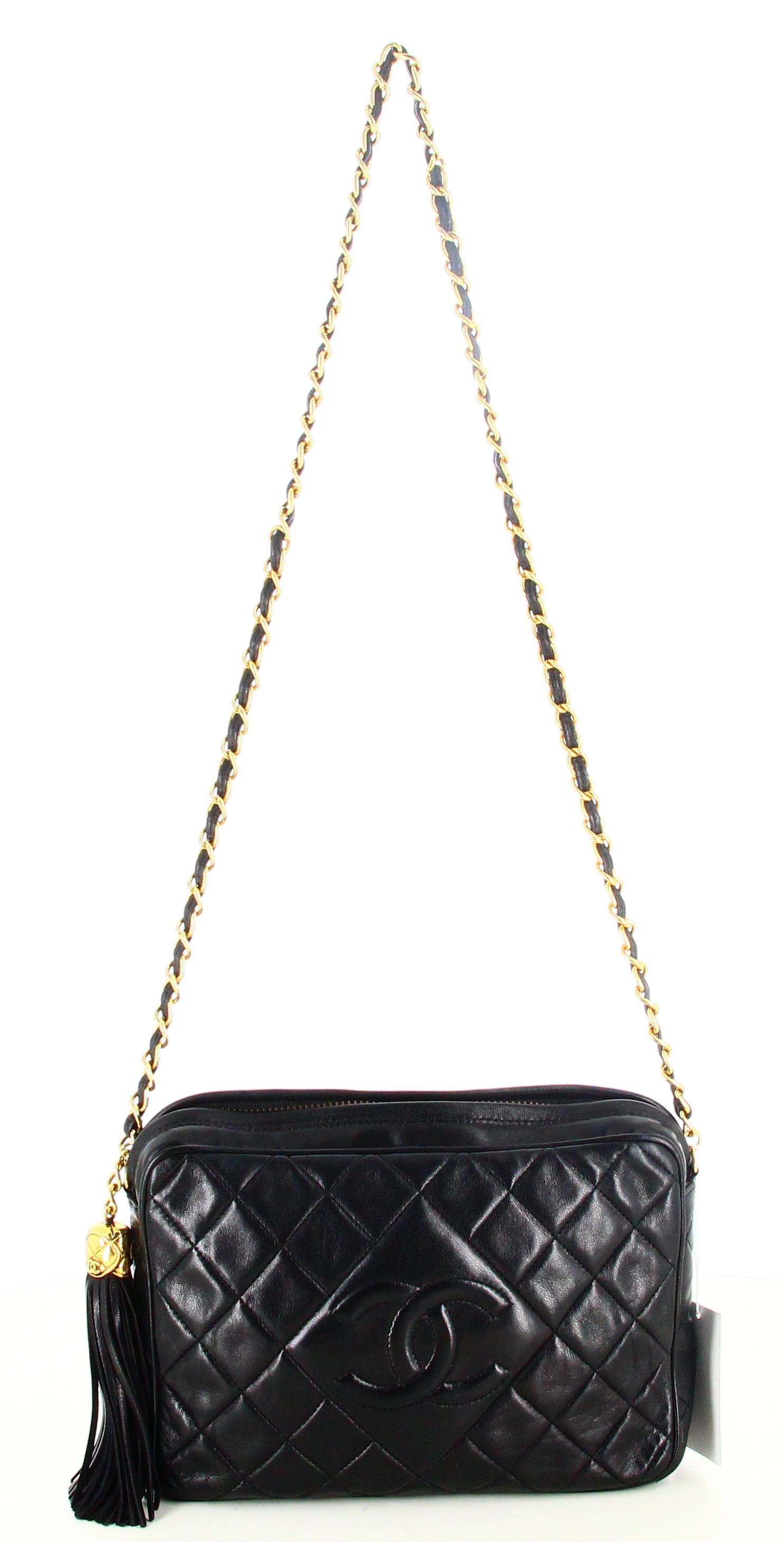 1989 Chanel CC Quilted Lambskin Tassel Camera Bag

- Very good condition. Shows very slight signs of wear over time. 
- Chanel shoulder bag 
- Black quilted leather
- Long golden chain shoulder strap 
- Inside: black leather plus inside pocket