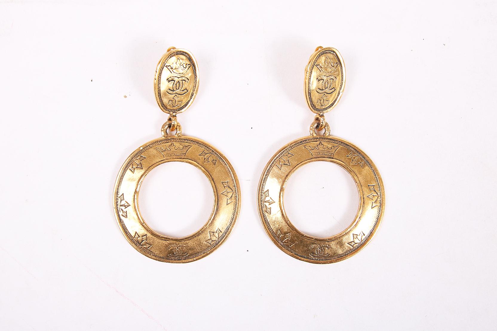 1989 Chanel hammered goldtone dangling clip-on hoop earrings made when Victoire de Castellane was head jewelry designer at Chanel. Etched with the iconic interlocking “CC” logo and crown motif. Marked  “Chanel Made in France