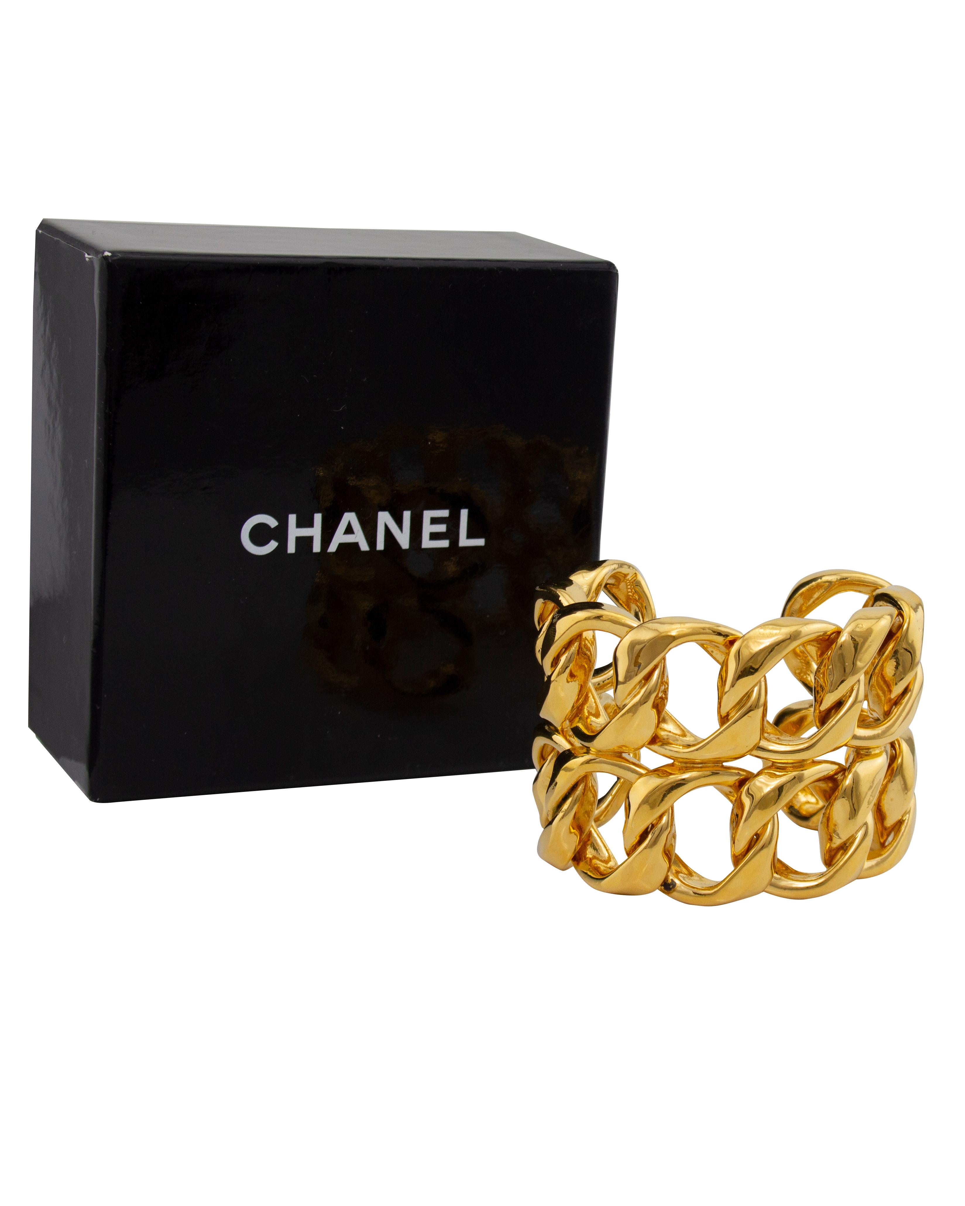 Original edition Collection 26 Chanel iconic interlocking double chain cuff bracelet in excellent condition. Gilt metal. No signs of surface wear or scratching. Original box. Rare . Average fit, non flexible.