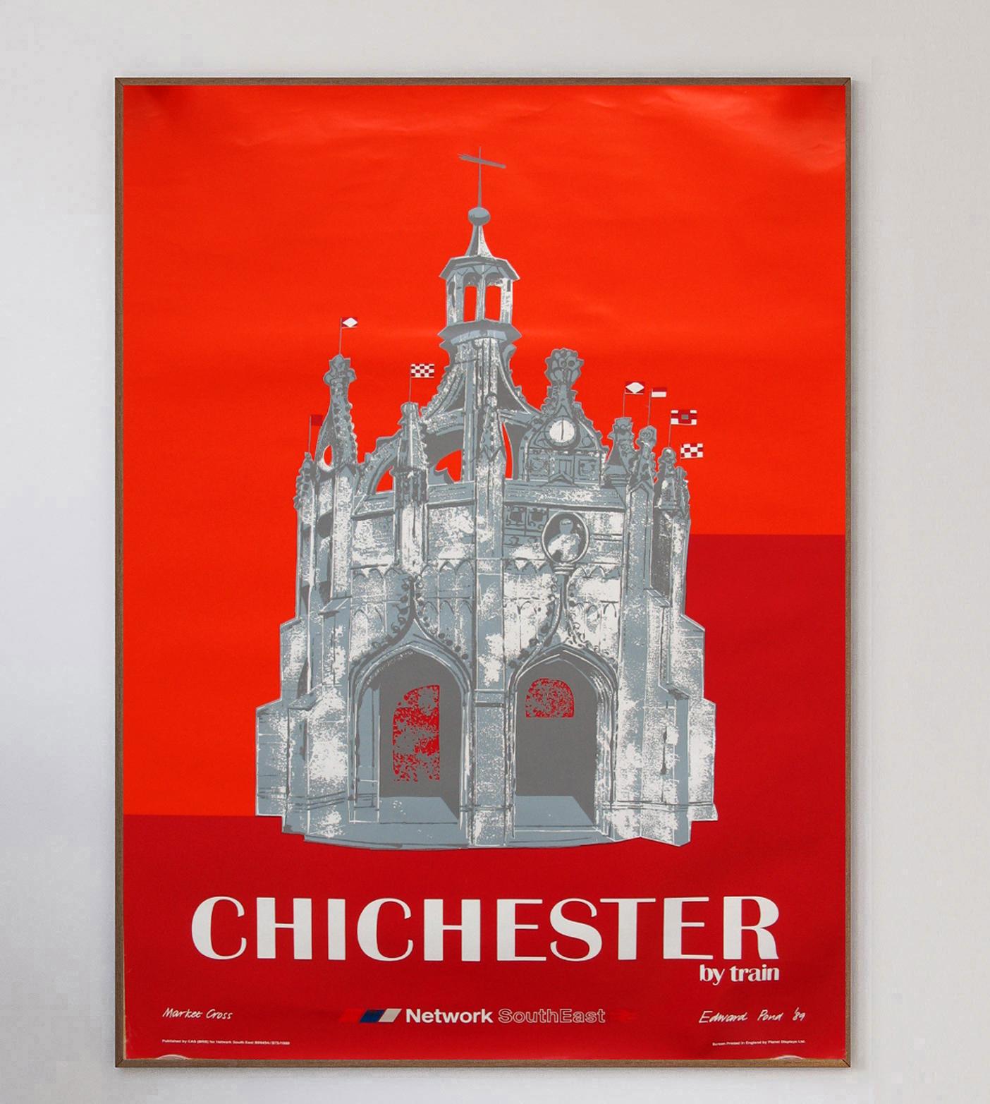 This beautiful poster was created in 1989 to promote British Railways new Network SouthEast region, and routes to the historic city of Chichester in West Sussex, England. The vibrant red design depicts the Market Cross in the city centre of