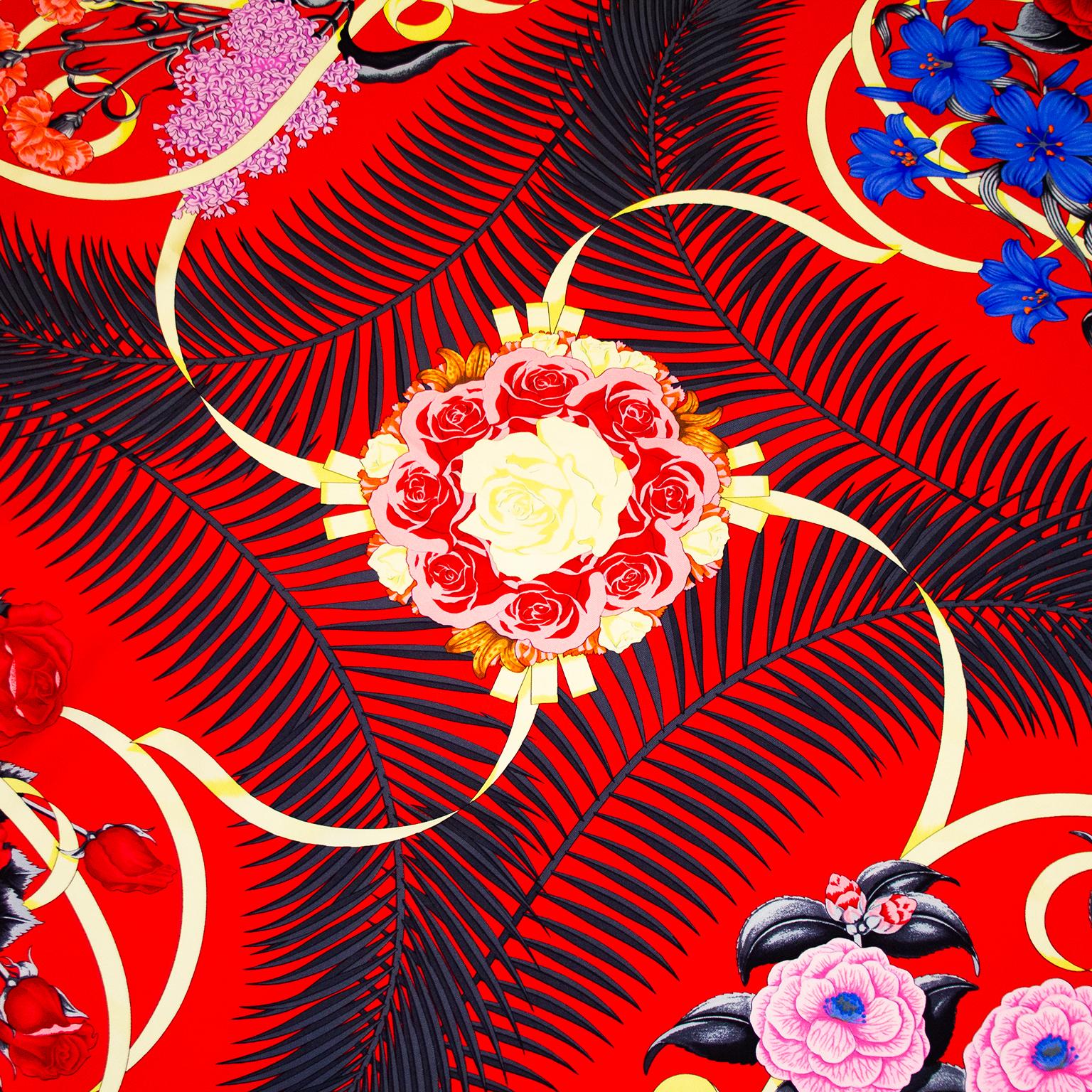 This fabulous vintage Hermès scarf, Fleurs de L'Opera by Julia Abadie was first issued in 1989. Here an original issue with a bold and dramatic red background featuring black, blue, pink and yellow floral details. A must have for any opera lover.