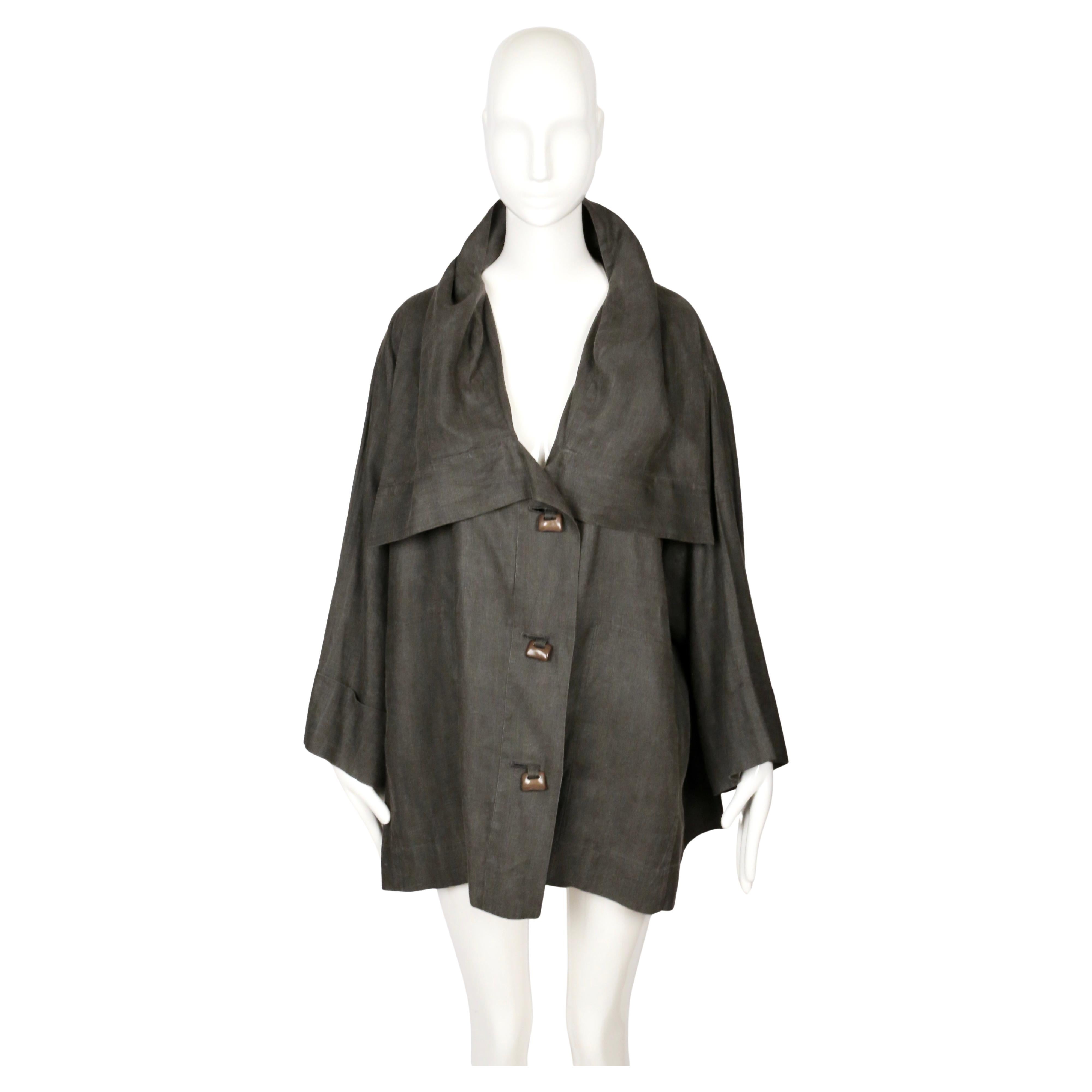 1980's Issey Miyake charcoal-gray linen coat with a wide sculptural collar that falls softly over the shoulders. The cut is loose and architectural, with organically shapped acetate toggle closures and full cuffed sleeves that add to its easy,