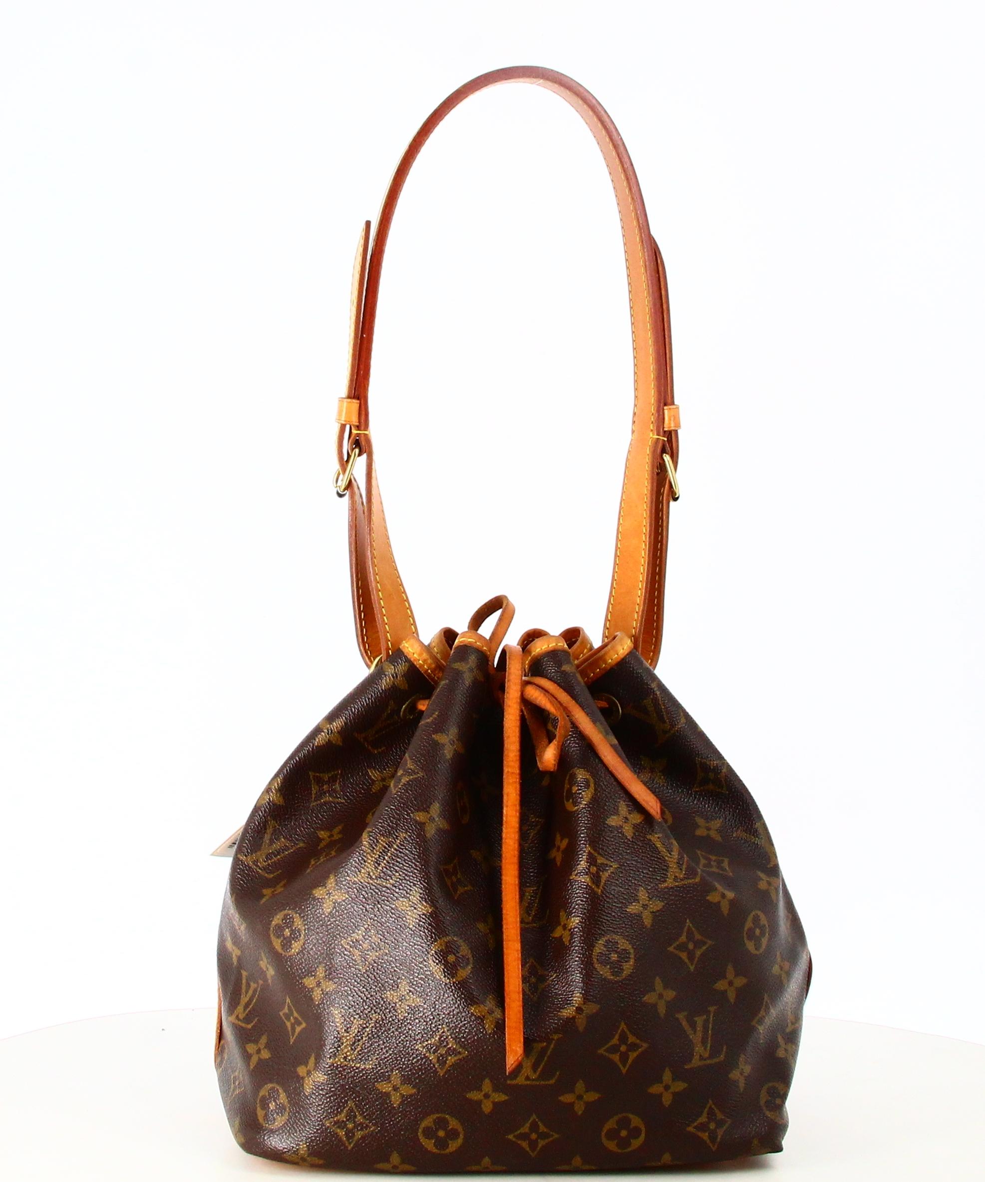 1989 Louis Vuitton Canvas Monogram Noe Handbag

- Very good condition. Shows very slight signs of wear over time. 
- Louis Vuitton Bag
- Monogram canvas
- Brown leather shoulder strap 
- Brown leather lace