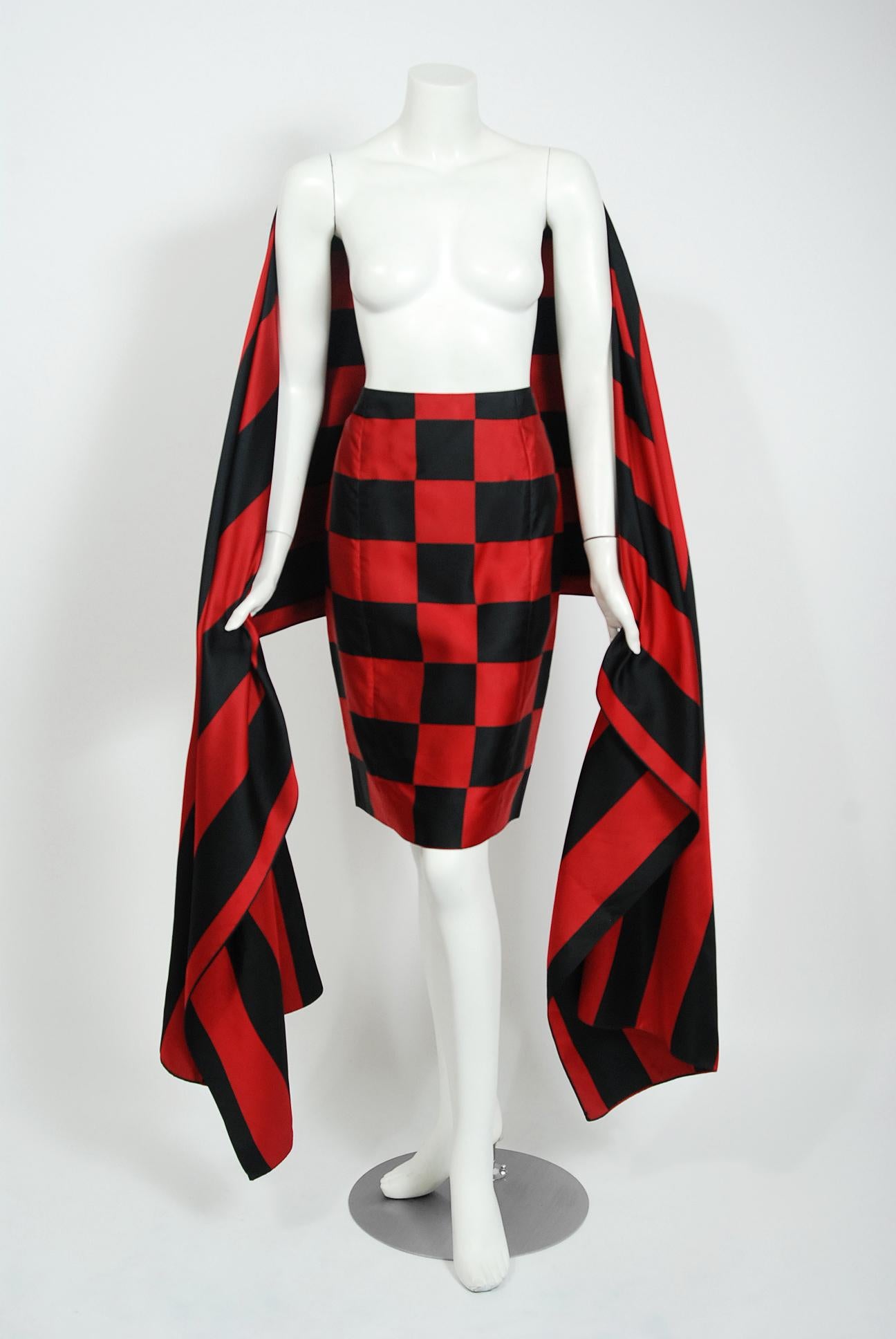 A gorgeous Perry Ellis by Marc Jacobs black and red checkered skirt with matching over-sized shawl wrap from his Fall/Winter 1989-90 collection. Not only is this rare set very alluring; it is so versatile and easy-to-wear. The minimal design