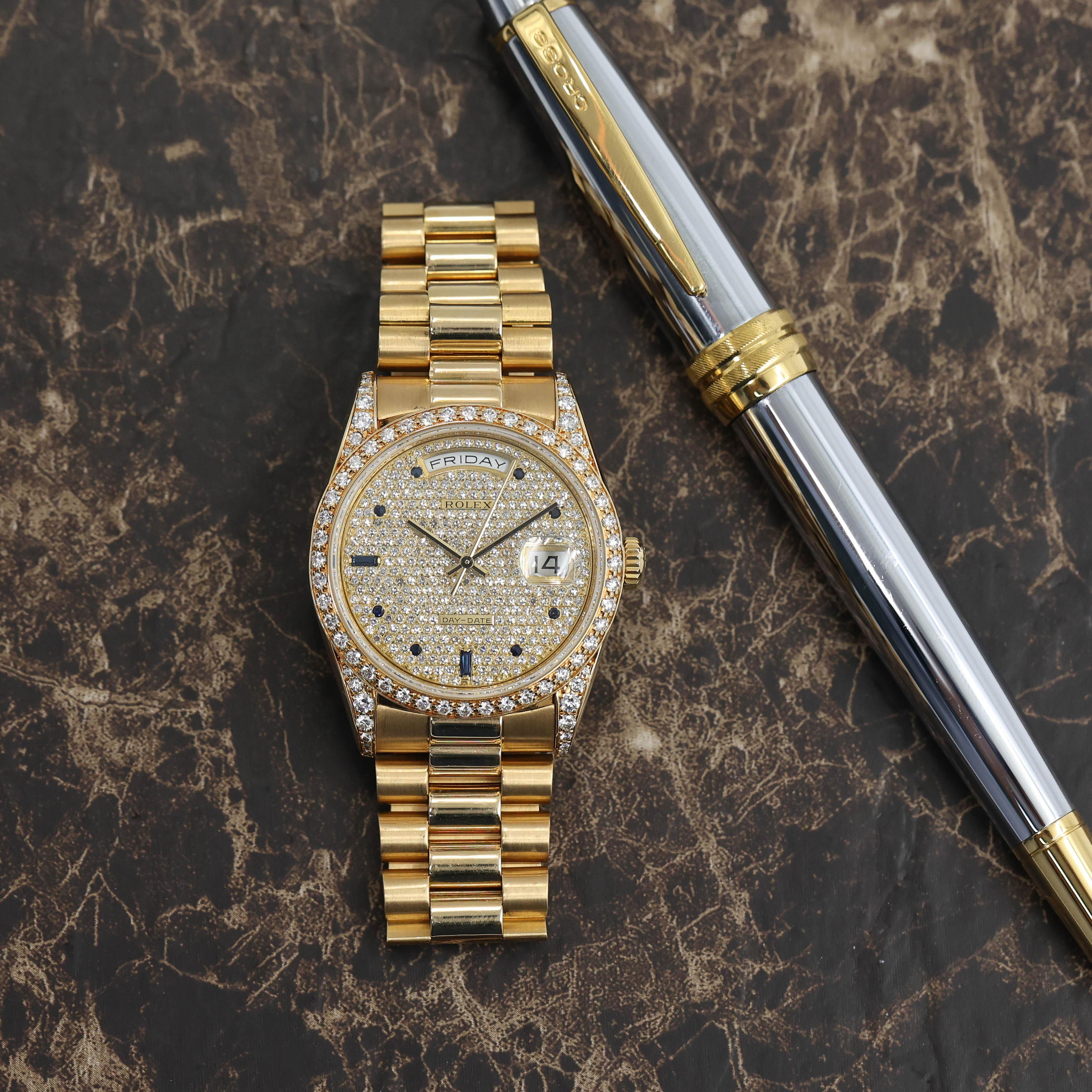 Diamonds & Sapphires - Here's a very glamorous Day Date 18388 in yellow gold. With factory diamond setting on the bezel as well as on the lugs. The watch features a beautiful Pavee dial with Sapphire markers and matching hands. The watch looks