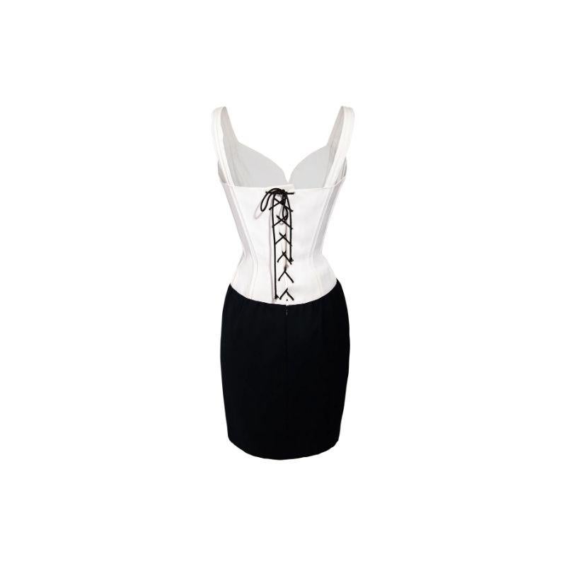1989 Thierry Mugler white and black mini dress, with corset lace up back and structured paneling throughout bodice. White upper is made of crepe material; black lower made of silk blend. In excellent vintage condition with no flaws to