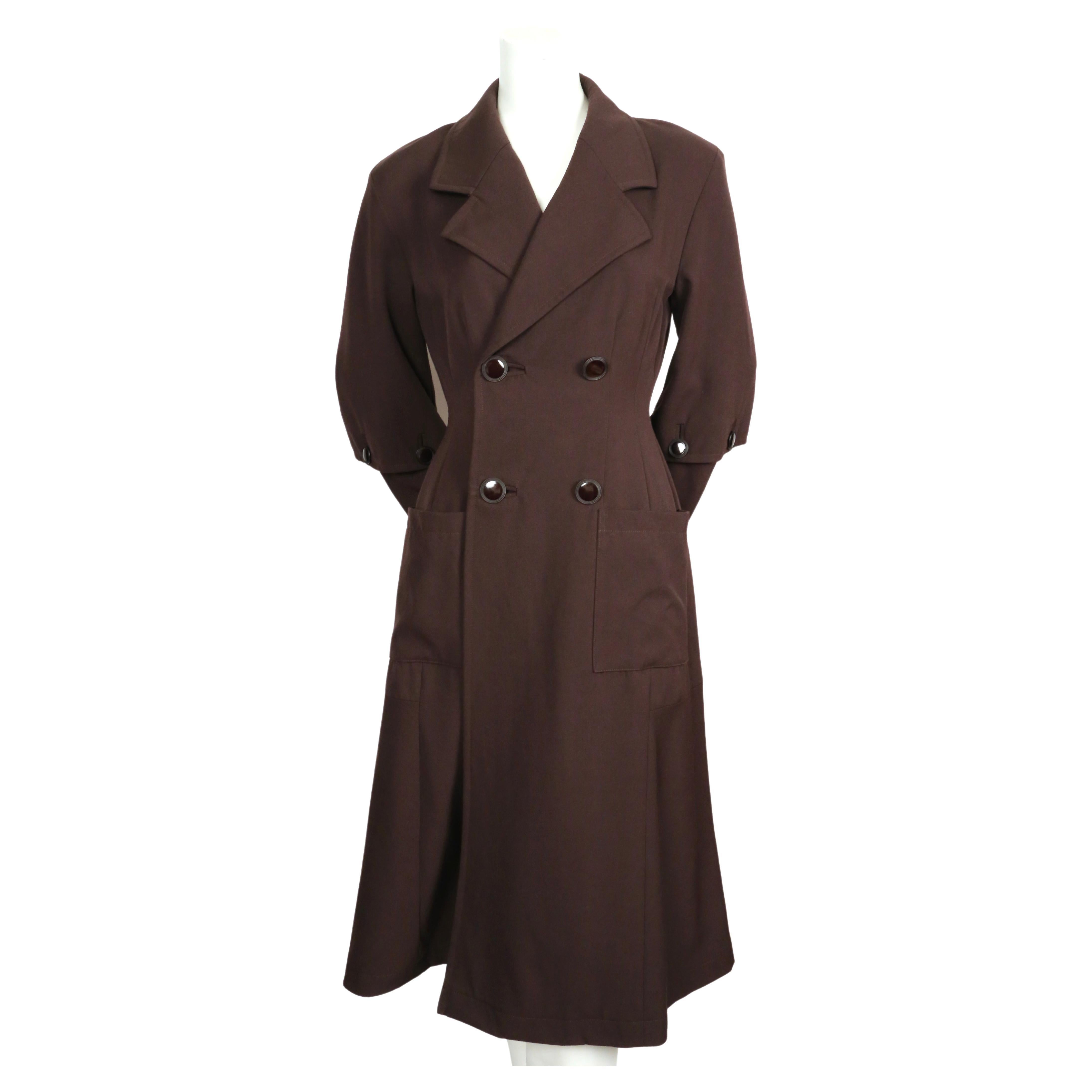 Very unique, dark brown wool coat with button detail at arms and back designed by Yohji Yamamoto dating to 1989 exactly as seen on the runway. Coat has a really great silhouette. Very flattering fit. Coat is labeled a size 'S', which best fits a US