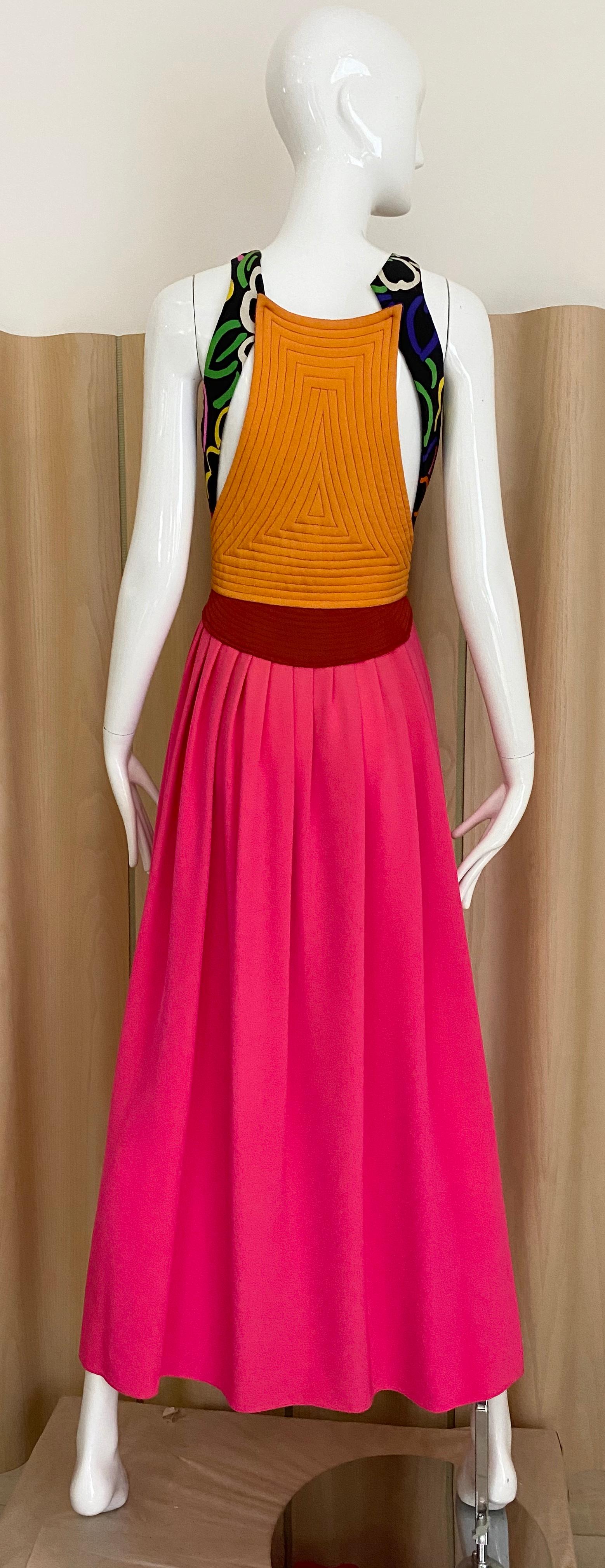 Beautiful Geoffrey Beene Hot pink, red, orange and black with multi color abstract print silk crepe  maxi dress with cut out side ( back). invisible front zipper.
Bust: 34”/  Waist: 26” 