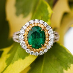 1.98ct Emerald 
1.2ct Diamond Halo 18ct Gold Ring
