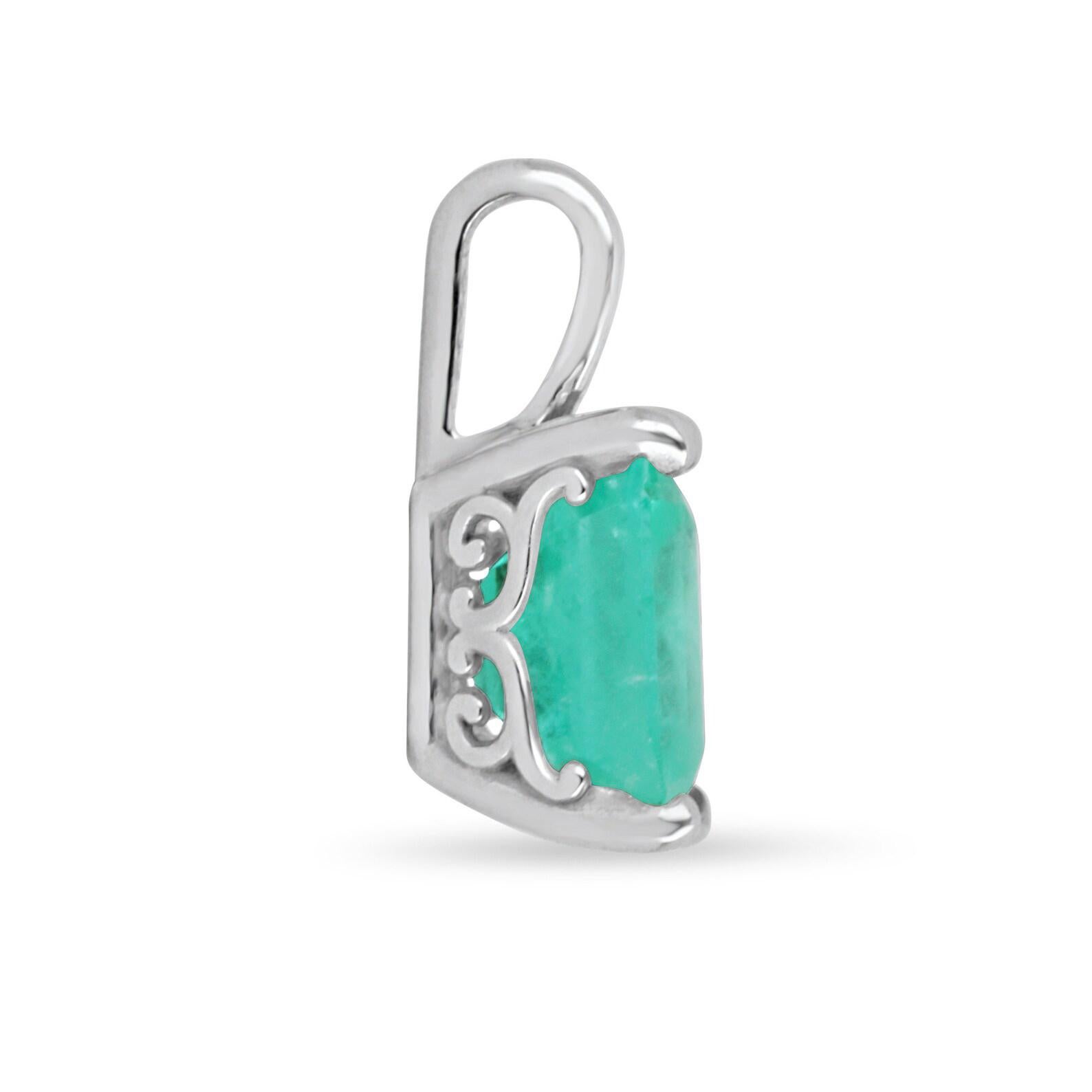 Displayed is a classic emerald solitaire necklace set in 14K white gold. This gorgeous solitaire pendant carries a full 1.98-carat emerald in a four-prong setting. Fully faceted, this gemstone showcases excellent shine. The gem has a vivid medium